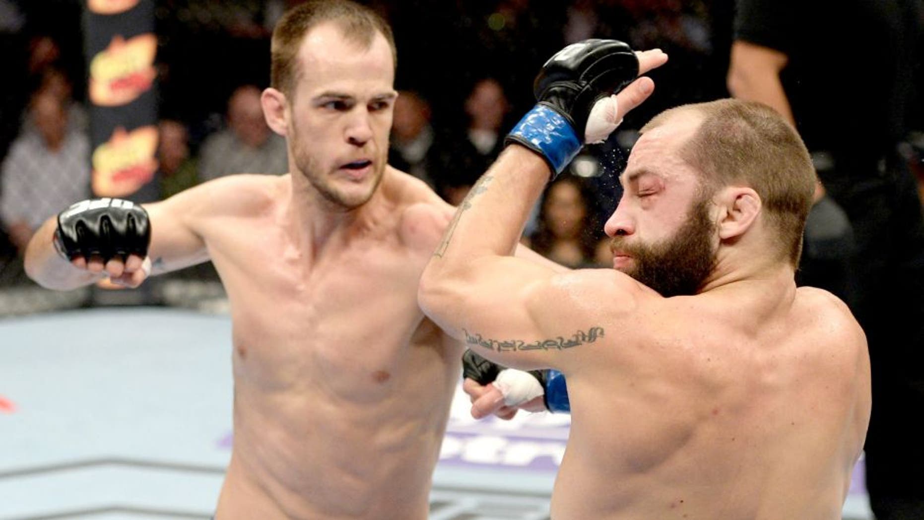DULUTH, GA - JANUARY 15: (L-R) Cole Miller punches Sam Sicilia in their featherweight fight during the UFC Fight Night event inside The Arena at Gwinnett Center on January 15, 2014 in Duluth, Georgia. (Photo by Jeff Bottari/Zuffa LLC/Zuffa LLC via Getty Images) *** Local Caption *** Sam Sicilia; Cole Miller