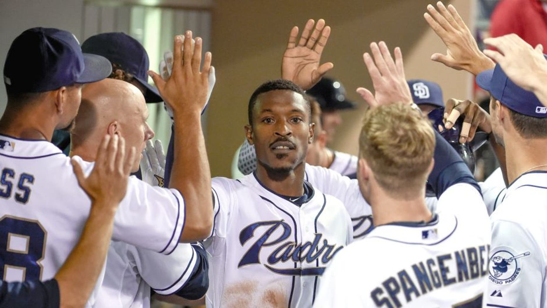 SAN DIEGO, CA - AUGUST 18: Melvin Upton Jr. #2 of the San Diego Padres, center, is congratulated after hitting a two-run home run during the sixth inning of a baseball game against the Atlanta Braves at Petco Park August 18, 2015 in San Diego, California. (Photo by Denis Poroy/Getty Images)