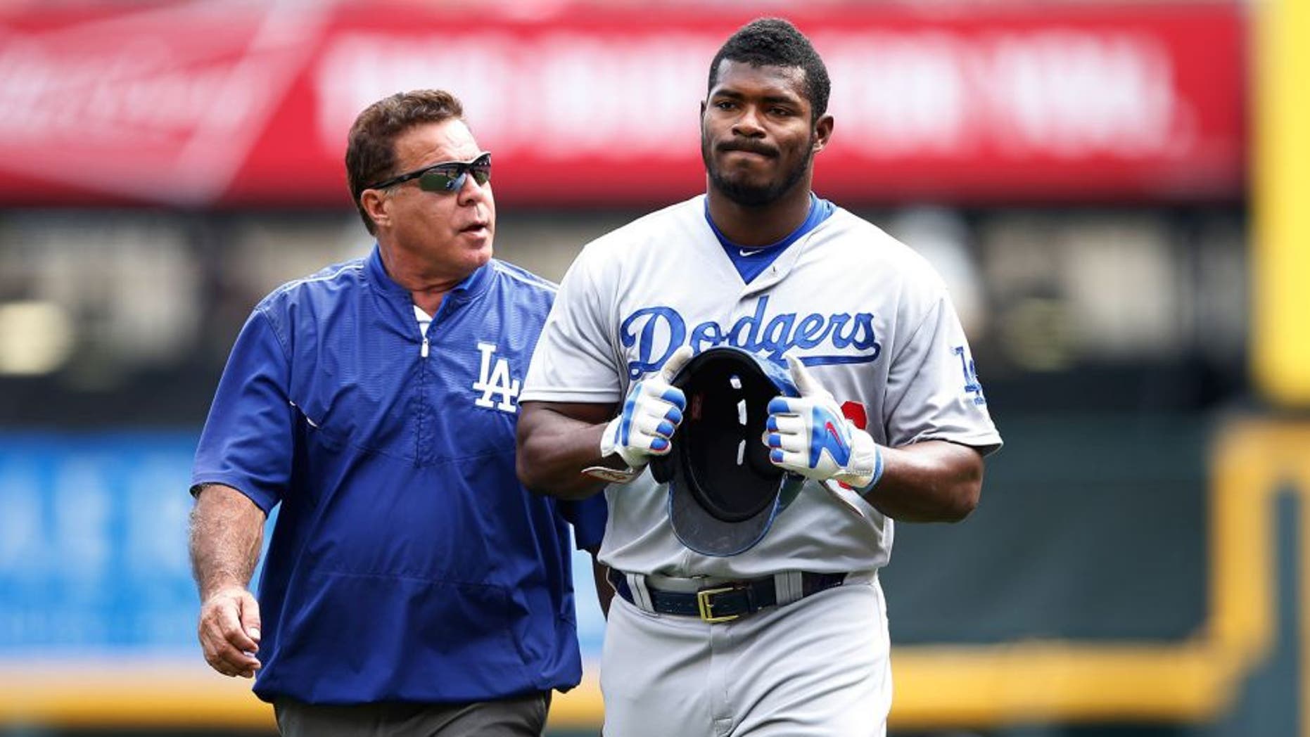 CINCINNATI, OH - AUGUST 27: Yasiel Puig #66 of the Los Angeles Dodgers leaves the field after suffering an injury beating out a throw to first base in the ninth inning against the Cincinnati Reds at Great American Ball Park on August 27, 2015 in Cincinnati, Ohio. The Dodgers defeated the Reds 1-0. (Photo by Joe Robbins/Getty Images)