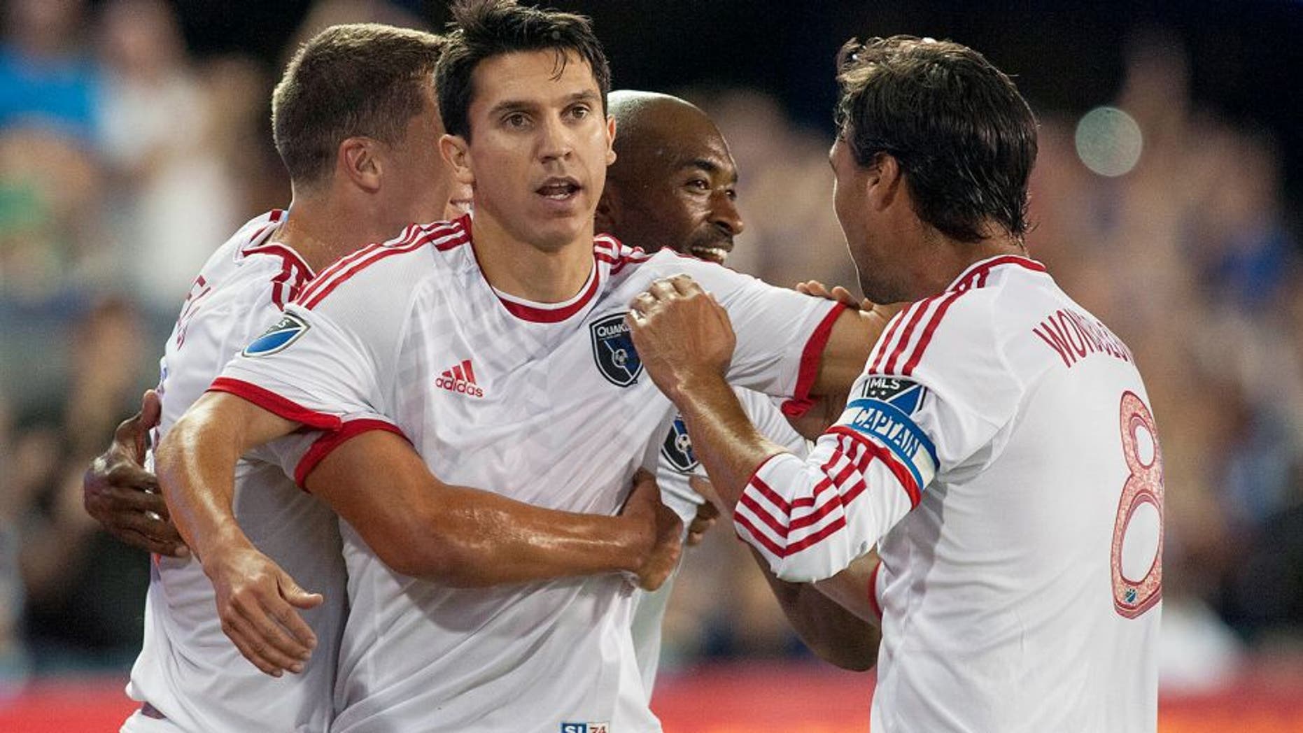 Aug 28, 2015; San Jose, CA, USA; San Jose Earthquakes midfielder Shea Salinas (6) celebrates with midfielder Marc Pelosi (33) and defender Marvell Wynne (4) and forward Chris Wondolowski (8) after scoring a goal against the Los Angeles Galaxy during the first half at Avaya Stadium. Mandatory Credit: Ed Szczepanski-USA TODAY Sports