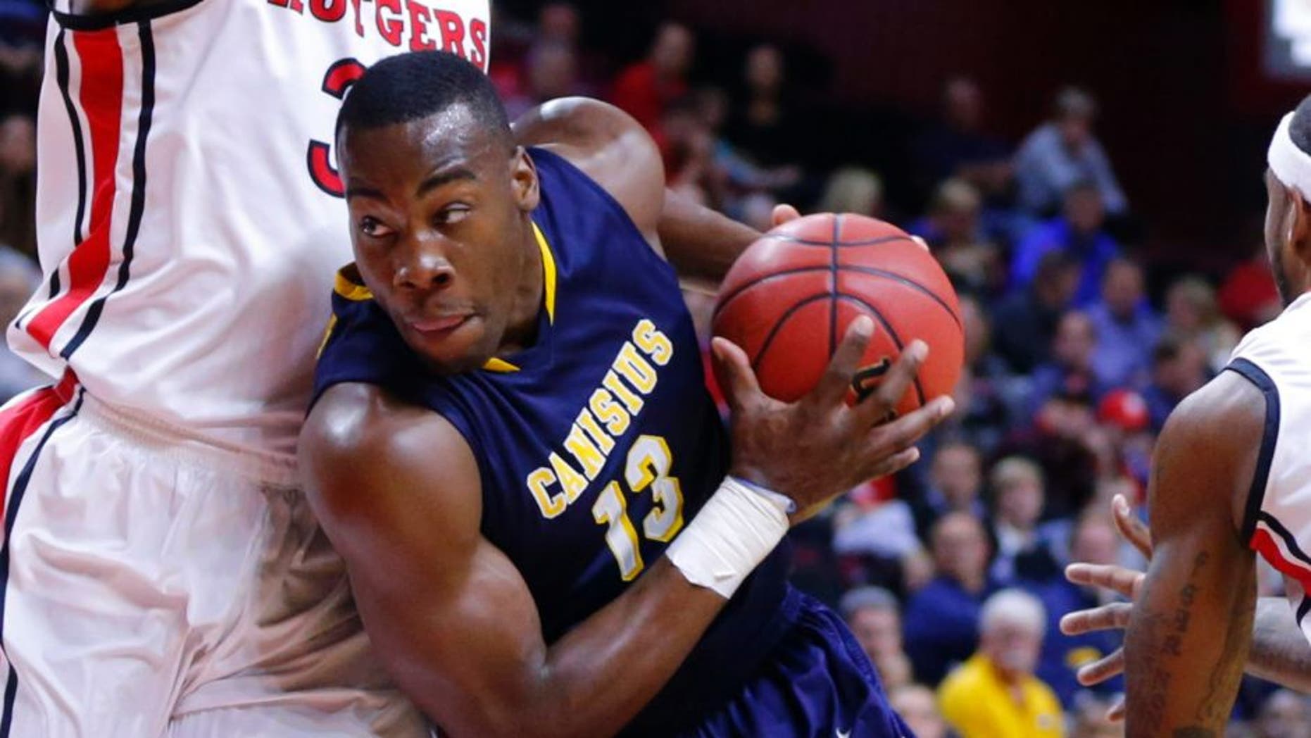 Nov 18, 2013; Piscataway, NJ, USA; Canisius Golden Griffins forward Chris Manhertz (13) drives to the basket during the first half against Rutgers Scarlet Knights forward Wally Judge (33) at the Louis Brown Athletic Center. Mandatory Credit: Jim O'Connor-USA TODAY Sports