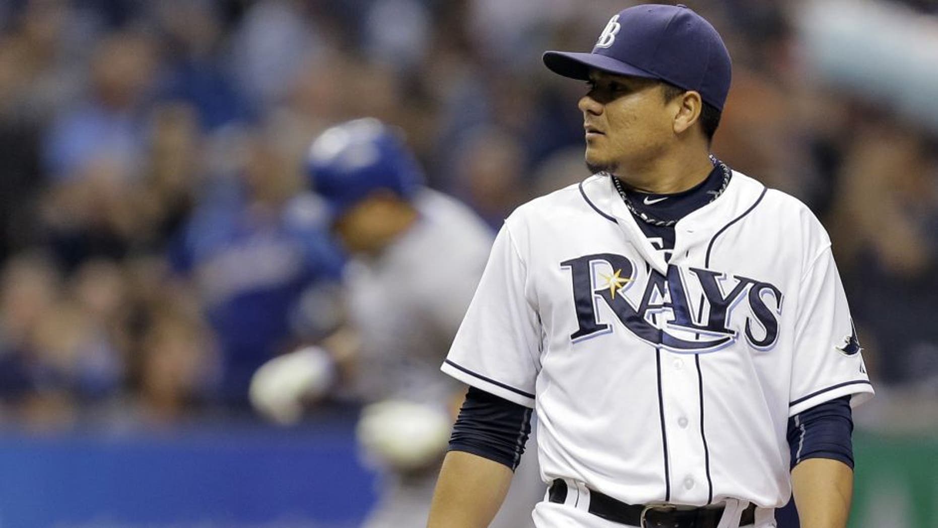 Tampa Bay Rays starting pitcher Erasmo Ramirez, foreground, looks at the home plate umpire as Kansas City Royals' Kendrys Morales runs the bases after hitting a two-run home run during the third inning of a baseball game Friday, Aug. 28, 2015, in St. Petersburg, Fla. (AP Photo/Chris O'Meara)