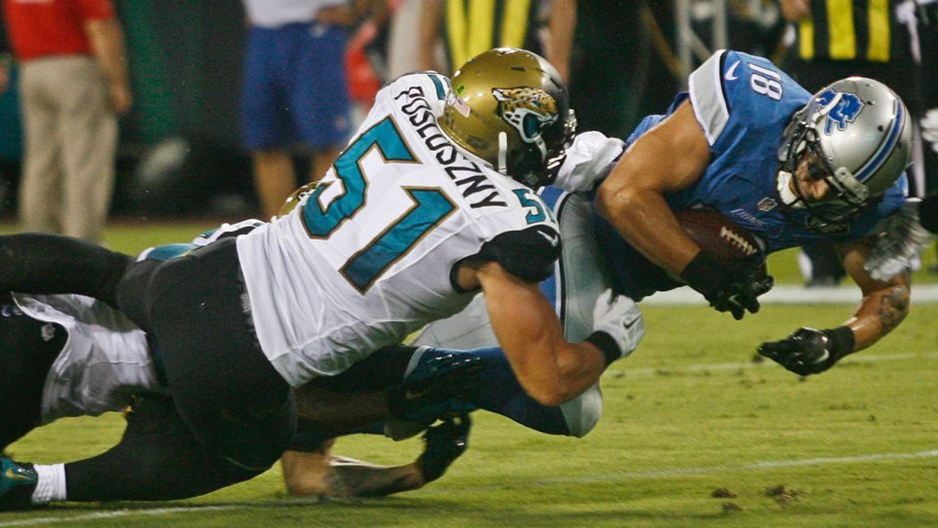 Aug 28, 2015; Jacksonville, FL, USA; Detroit Lions wide receiver Greg Salas (18) dives for extra yardage as Jacksonville Jaguars linebacker Paul Posluszny (51) tackles in the second quarter of a preseason NFL football game at EverBank Field. Mandatory Credit: Phil Sears-USA TODAY Sports