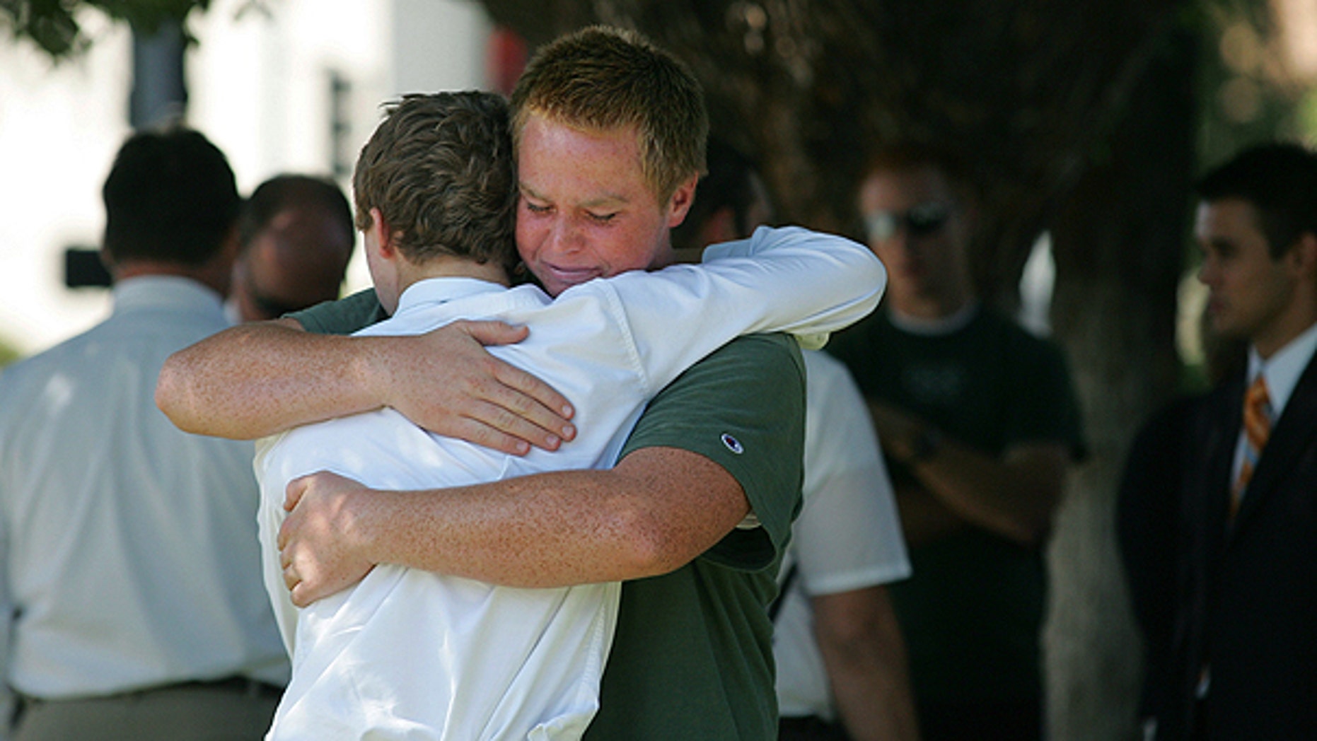 Aug. 29: Stephen Henriksen, right, gets a hug from fellow church member Ryan Henshaw after a shooting that killed lay bishop Clay Sannar of the Church of Jesus Christ of Latter-Day Saints in Visalia, Calif.