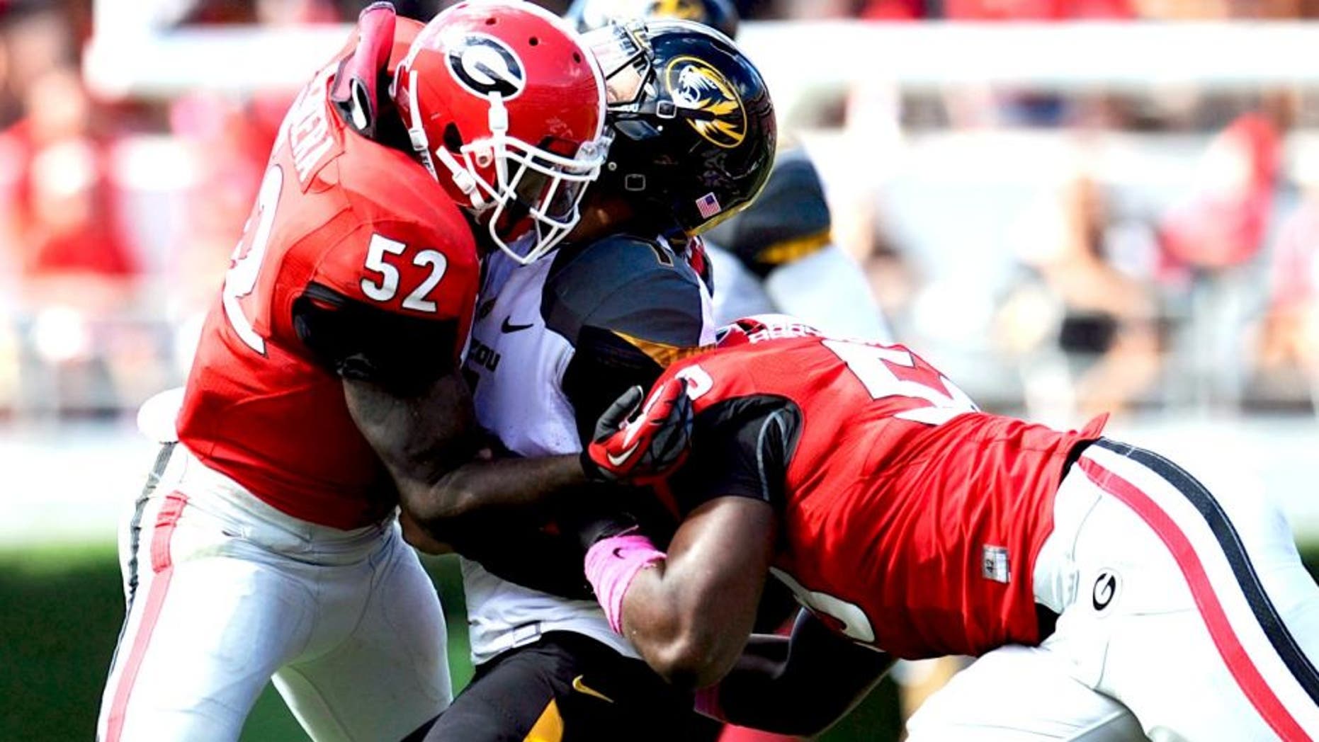 Oct 12, 2013; Athens, GA, USA; Missouri Tigers quarterback James Franklin (1) is injured and leaves the game after being hit by Georgia Bulldogs linebacker Jordan Jenkins (59) and linebacker Amarlo Herrera (52) during the second half at Sanford Stadium. Missouri defeated Georgia 41-26. Mandatory Credit: Dale Zanine-USA TODAY Sports