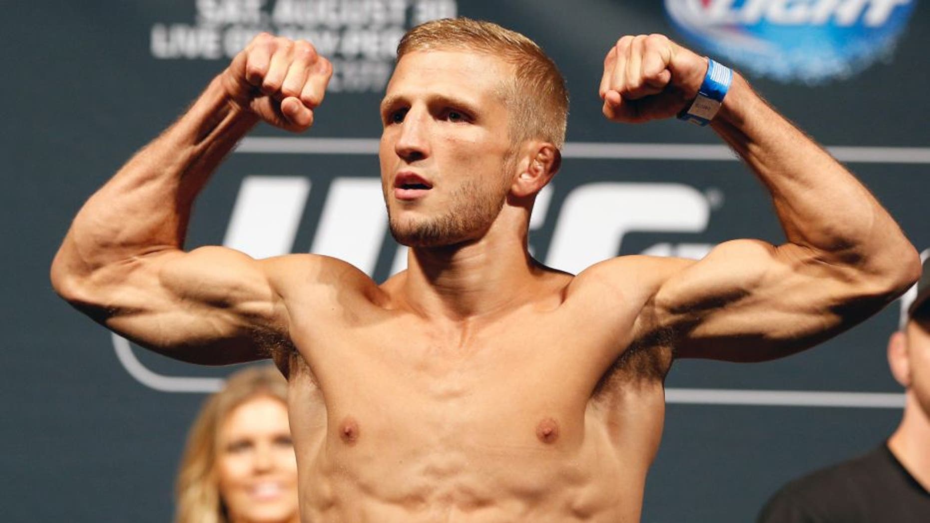 SACRAMENTO, CA - AUGUST 29: UFC bantamweight champion T.J. Dillashaw weighs in during the UFC 177 weigh-in at Sleep Train Arena on August 29, 2014 in Sacramento, California. (Photo by Josh Hedges/Zuffa LLC/Zuffa LLC via Getty Images)
