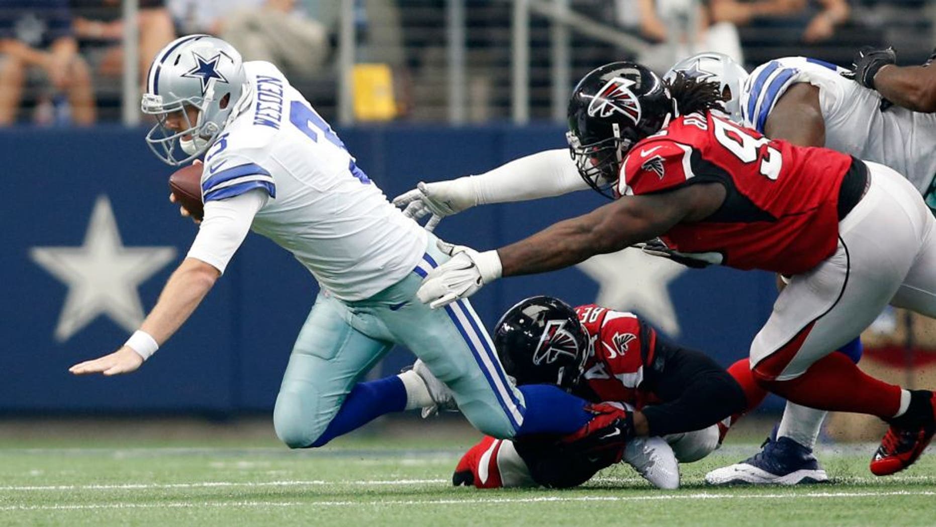 Sep 27, 2015; Arlington, TX, USA; Dallas Cowboys quarterback Brandon Weeden (3) is sacked by Atlanta Falcons linebacker Vic Beasley (44) and defensive tackle Jonathan Babineaux (95) in the fourth quarter in at AT&T Stadium. Atlanta won 39-28. Mandatory Credit: Tim Heitman-USA TODAY Sports