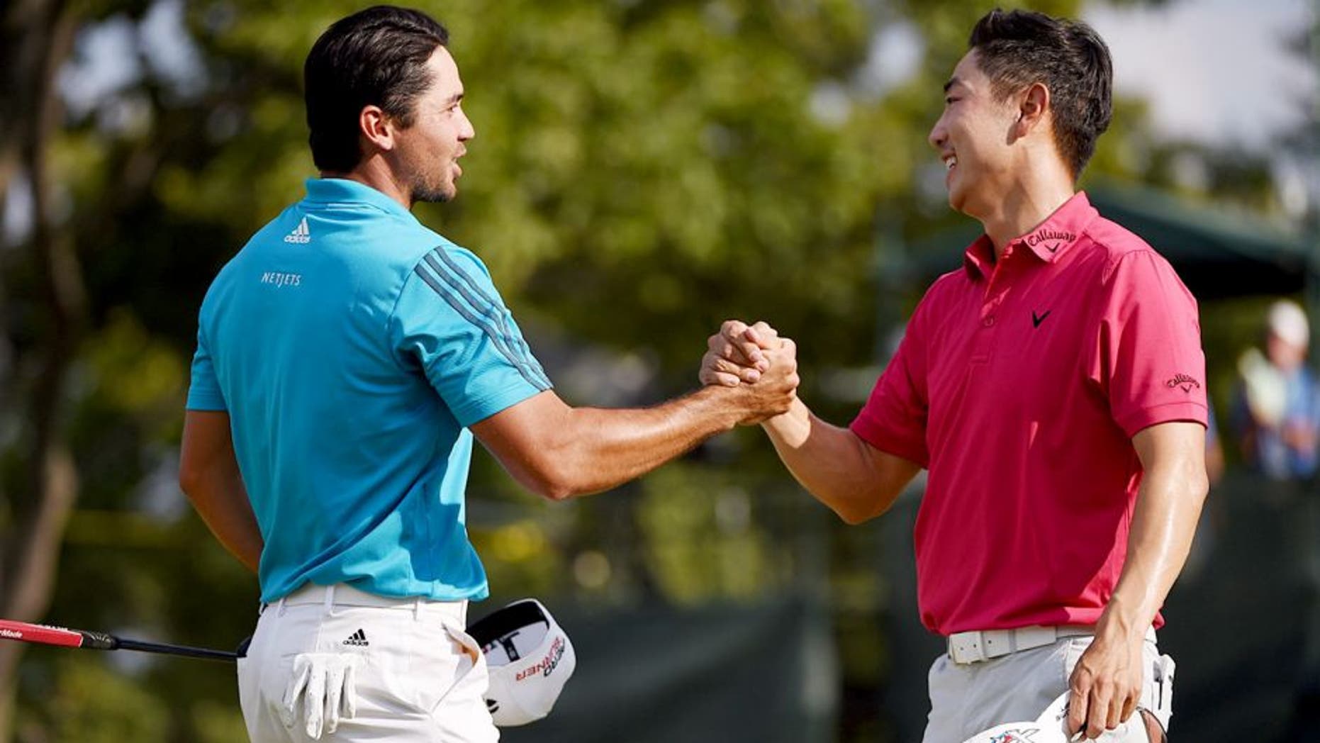 EDISON, NJ - AUGUST 29: Jason Day of Australia (L) and Sang-Moon Bae of Korea shake hands on the18th green during the third round of The Barclays at Plainfield Country Club on August 29, 2015 in Edison, New Jersey. (Photo by Ross Kinnaird/Getty Images)