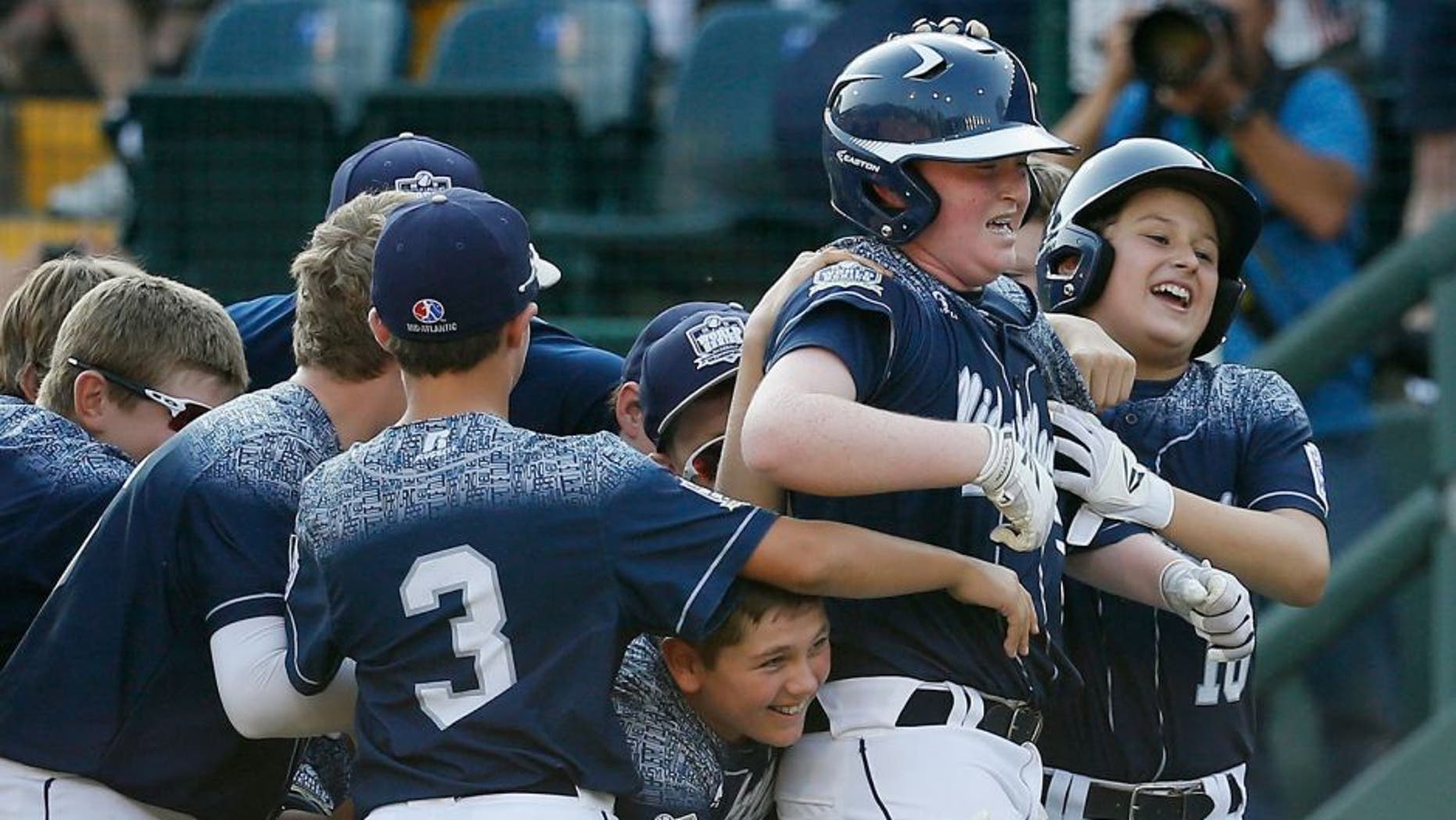 SOUTH WILLAMSPORT, PA - AUGUST 29: Clayton Krauss #25 of the Mid-Atlantic team from Red Land Little League of Lewisberry, Pennsylvania (C) celebrates with teammates after hitting a walk off single against the Southwest team from Pearland West Little League of Pearland, Texas for a 3-2 win during the United States Championship game of the Little League World Series at Lamade Stadium on August 29, 2015 in South Willamsport, Pennsylvania. (Photo by Rob Carr/Getty Images)