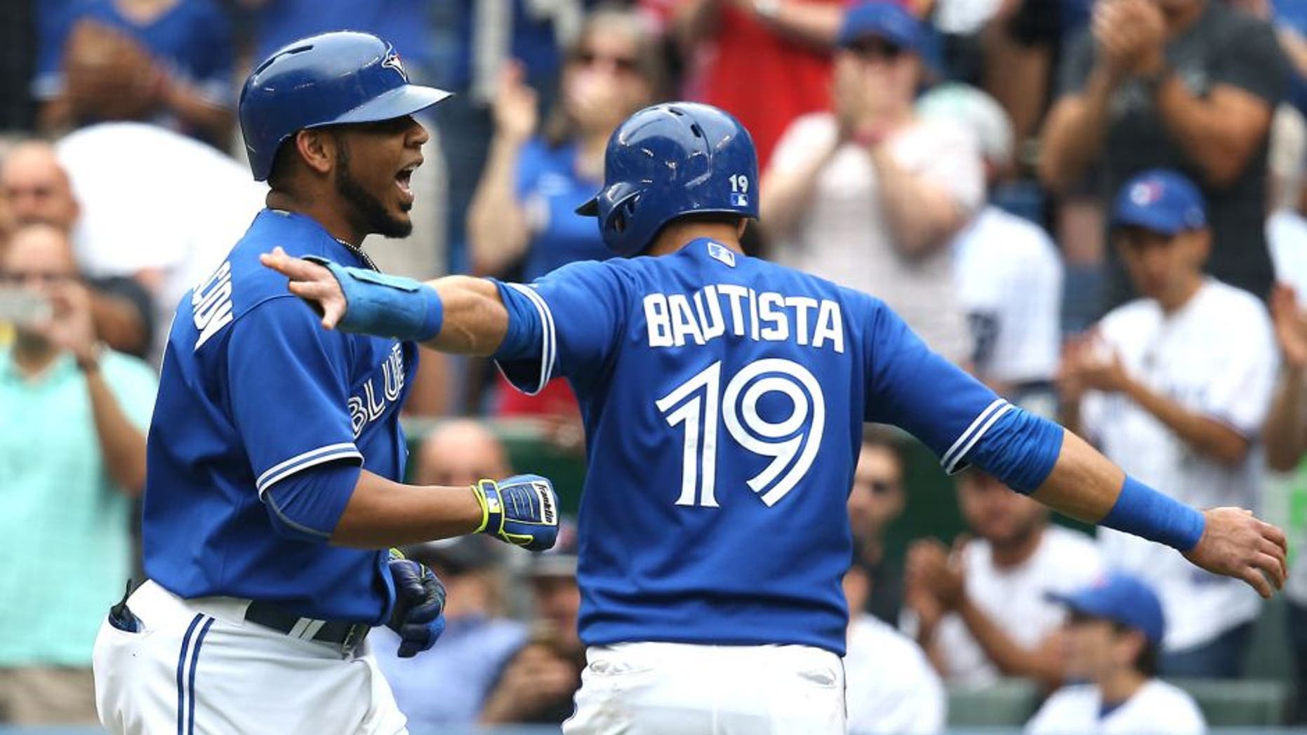 TORONTO, CANADA - AUGUST 29: Edwin Encarnacion #10 of the Toronto Blue Jays is congratulated by Jose Bautista #19 after hitting a three-run home run in the first inning during MLB game action against the Detroit Tigers on August 29, 2015 at Rogers Centre in Toronto, Ontario, Canada. (Photo by Tom Szczerbowski/Getty Images)
