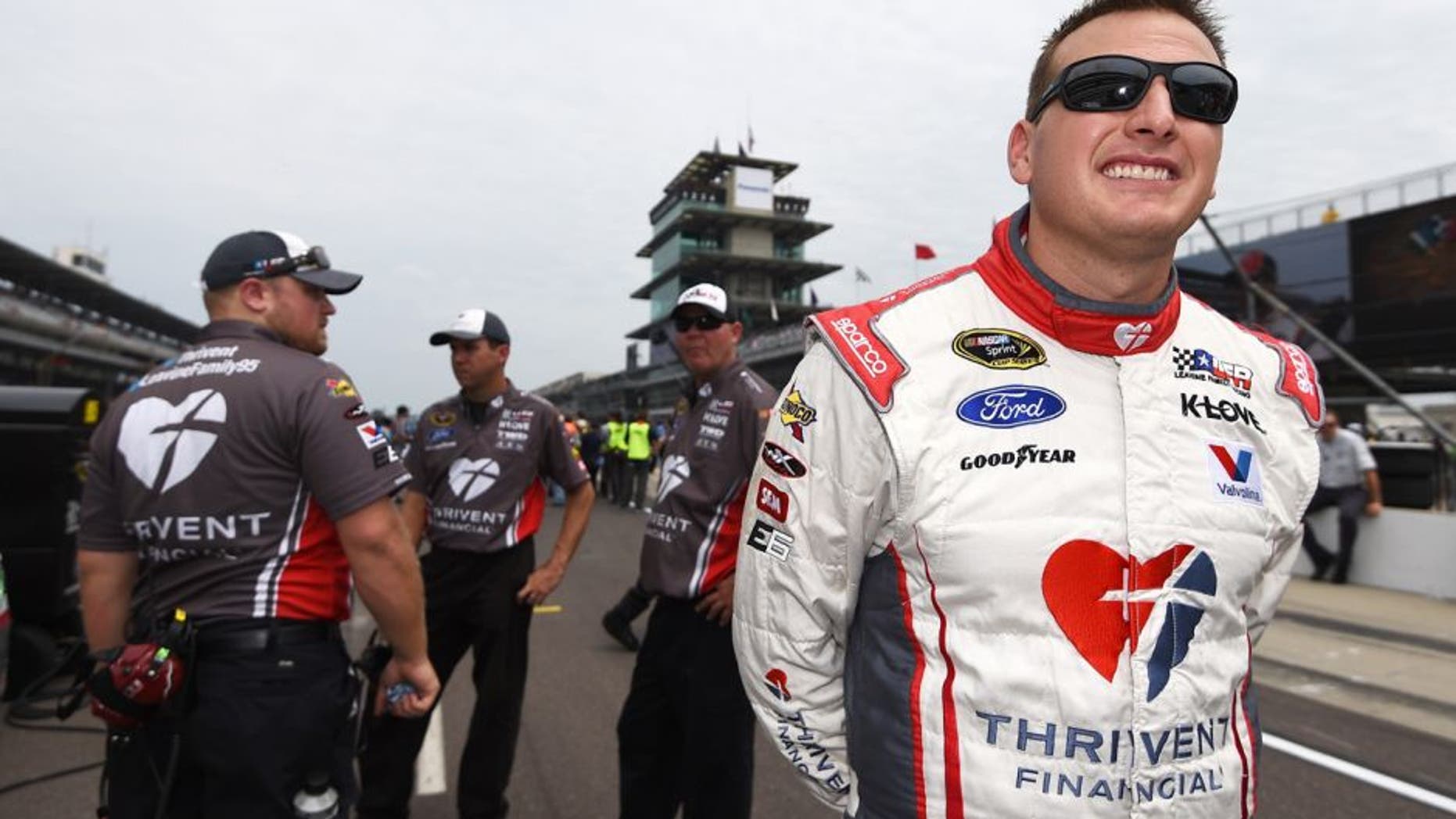 INDIANAPOLIS, IN - JULY 25: Michael McDowell, driver of the #95 Thrivent Financial Ford, stands on the grid during qualifying for the NASCAR Sprint Cup Series Crown Royal Presents the Jeff Kyle 400 at the Brickyard at Indianapolis Motor Speedway on July 25, 2015 in Indianapolis, Indiana. (Photo by Rainier Ehrhardt/NASCAR via Getty Images)