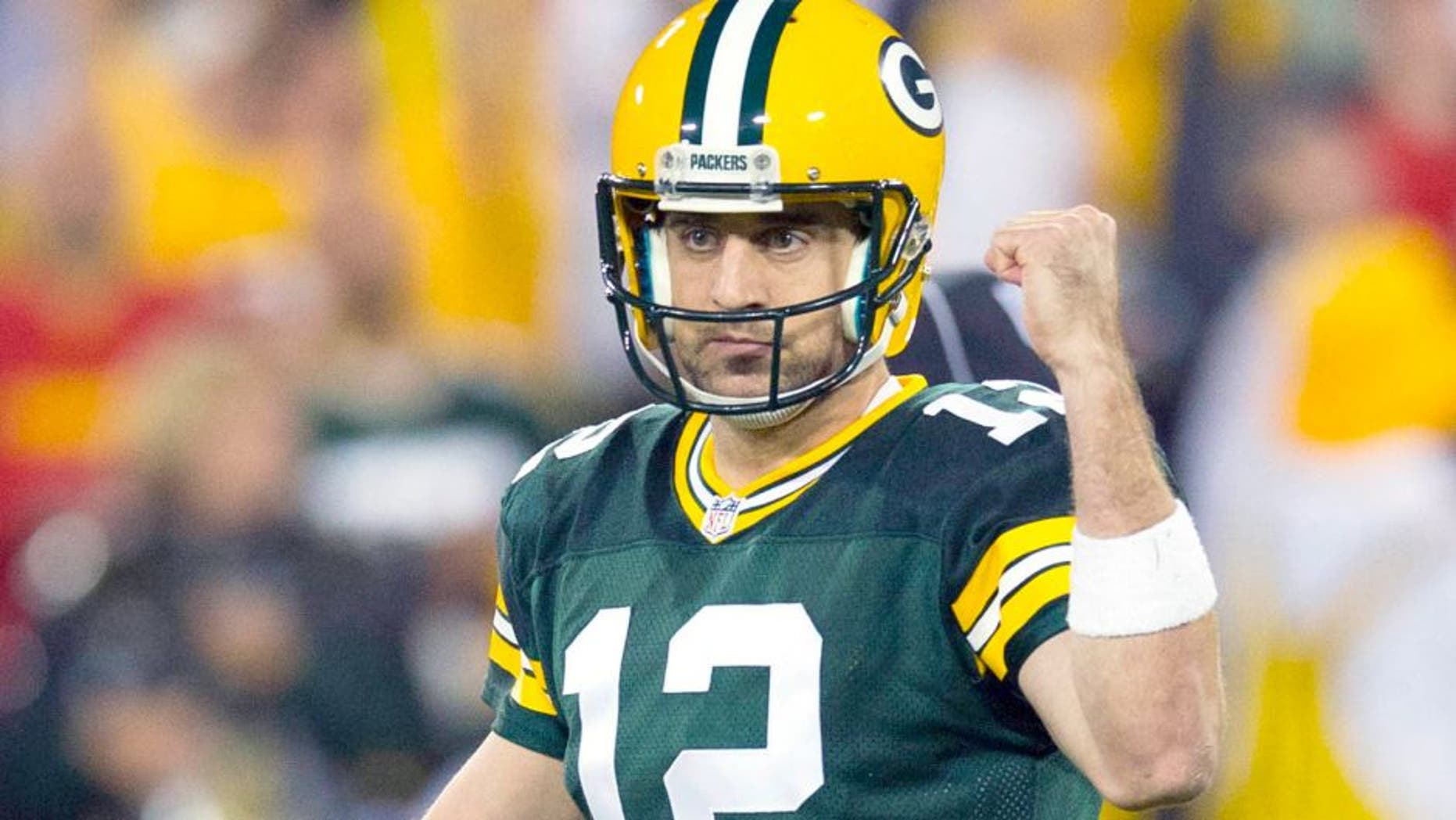 Sep 28, 2015; Green Bay, WI, USA; Green Bay Packers quarterback Aaron Rodgers (12) celebrates a touchdown pass during the first quarter against the Kansas City Chiefs at Lambeau Field. Mandatory Credit: Jeff Hanisch-USA TODAY Sports
