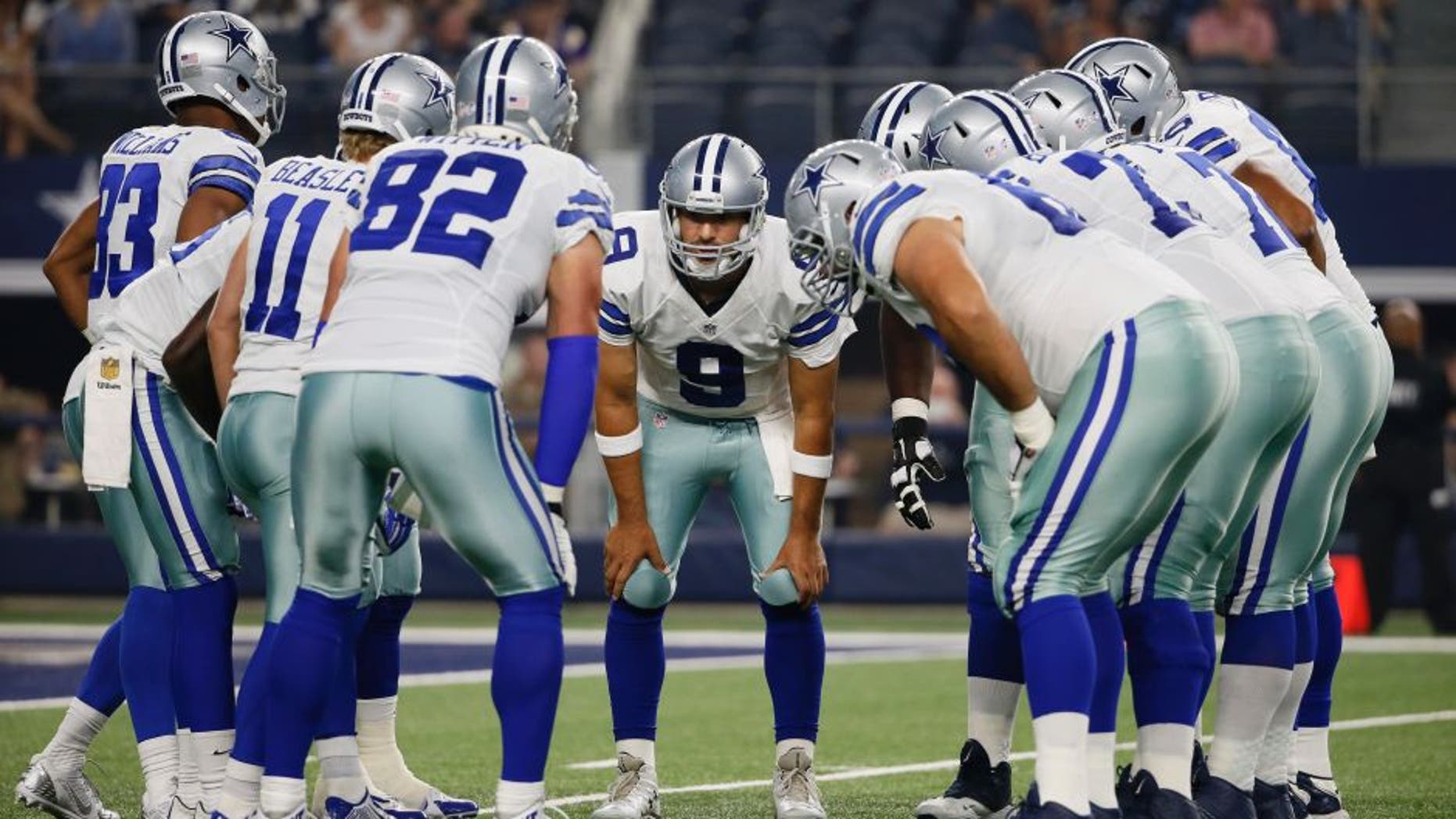 Dallas Cowboys quarterback Tony Romo (9) huddles with the team against the Minnesota Vikings during the first half of a preseason NFL football game Saturday, Aug. 29, 2015, in Arlington, Texas. (AP Photo/Tony Gutierrez)