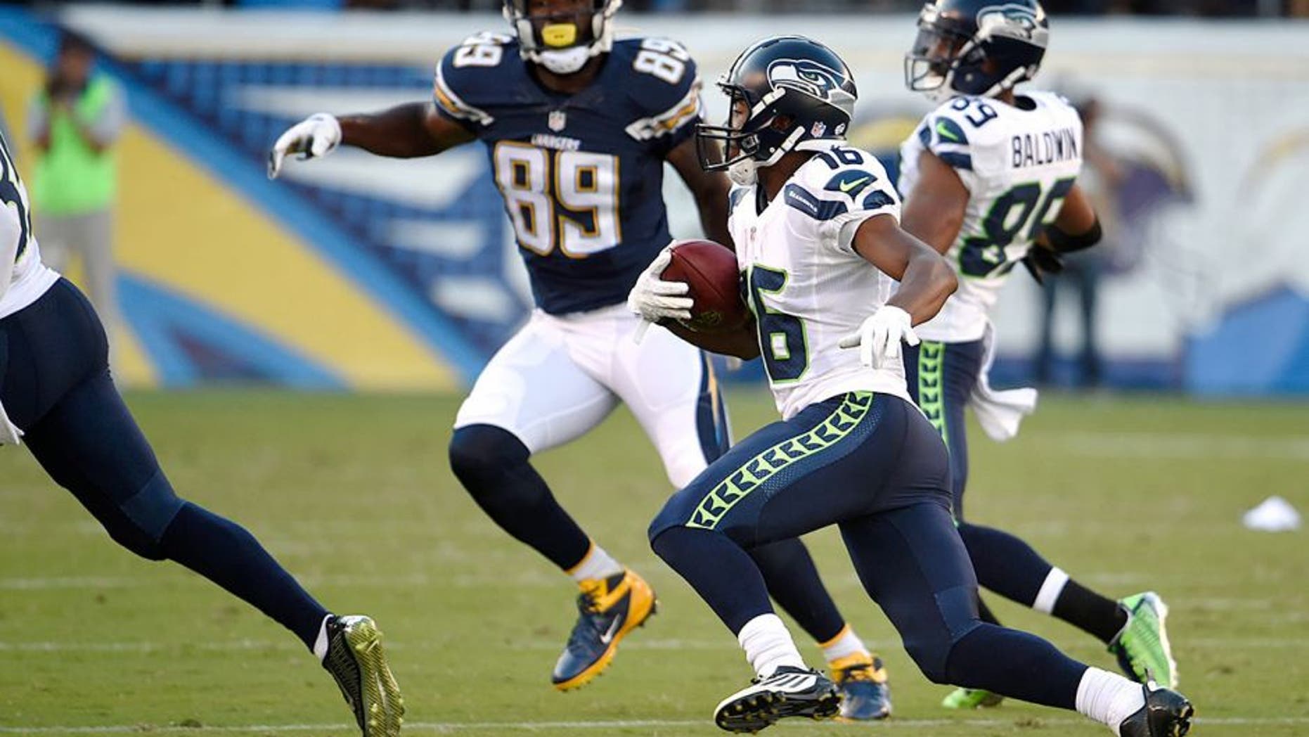 Seattle Seahawks wide receiver Tyler Lockett, second from right, returns a punt for a touchdown against the San Diego Chargers during the first half of a preseason NFL football game Saturday, Aug. 29, 2015, in San Diego. (AP Photo/Denis Poroy)