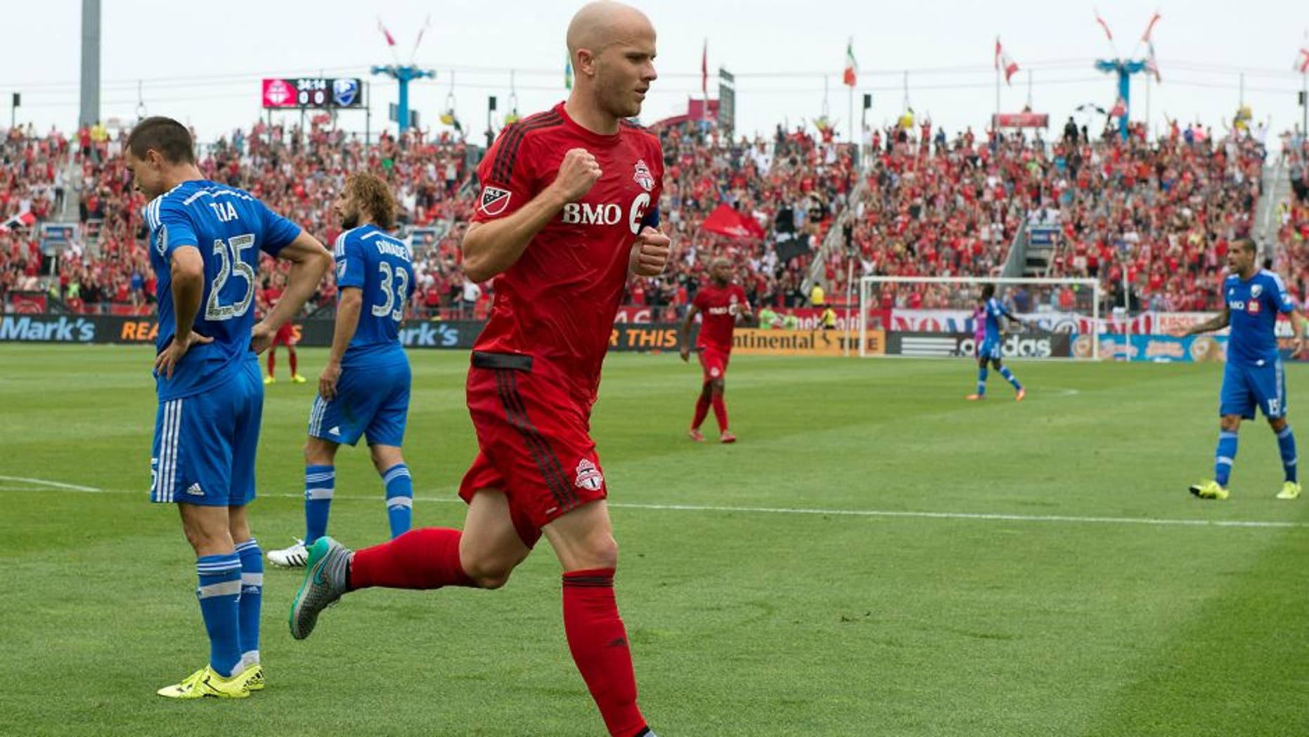 Aug 29, 2015; Toronto, Ontario, CAN; Toronto FC midfielder Michael Bradley (4) celebrates after scoring a goal during the first half in a game against the Montreal Impact at BMO Field. Mandatory Credit: Nick Turchiaro-USA TODAY Sports