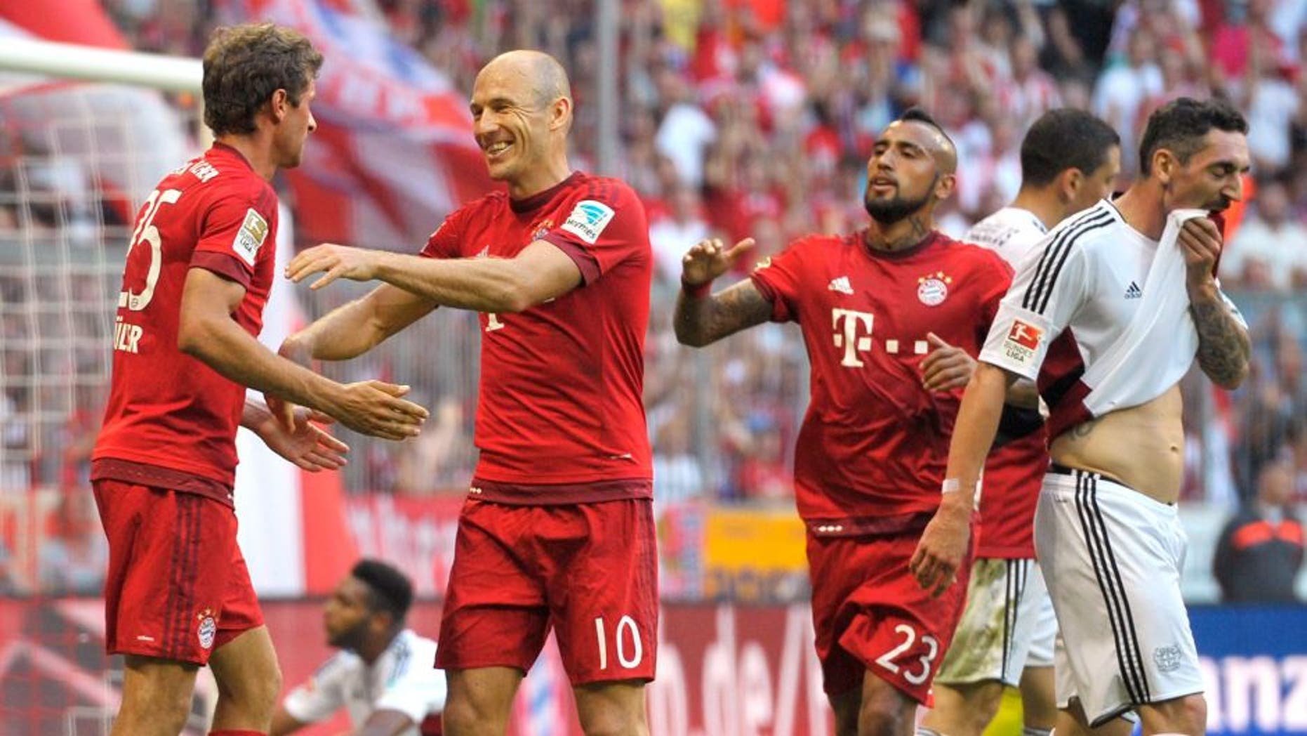 MUNICH, GERMANY - AUGUST 29: Thomas Mueller (L-R), Arjen Robben and Arturo Vidal of FC Bayern Muenchen celebrate scoring the opening goal during the Bundesliga match between FC Bayern Muenchen and Bayer Leverkusen at Allianz Arena on August 29, 2015 in Munich, Germany. (Photo by L. Preiss/Getty Images for FC Bayern)