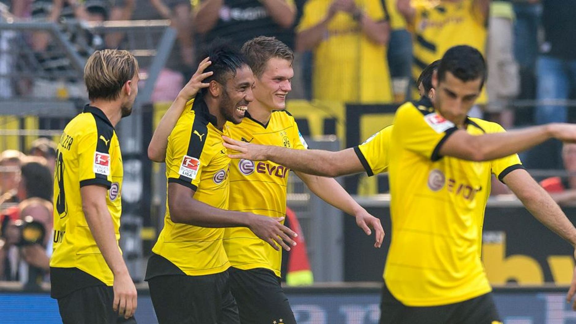 DORTMUND, GERMANY - AUGUST 30: Pierre-Emerick Aubameyang of Borussia Dortmund celebrates scoring the goal to the 2:0 together with his team mates Matthias Ginter, Marcel Schmelzer and Henrikh Mkhitaryan during the Bundesliga match between Borussia Dortmund and Hertha BSC at Signal Iduna Park on August 30, 2015 in Dortmund, Germany. (Photo by Alexandre Simoes/Borussia Dortmund/Getty Images)