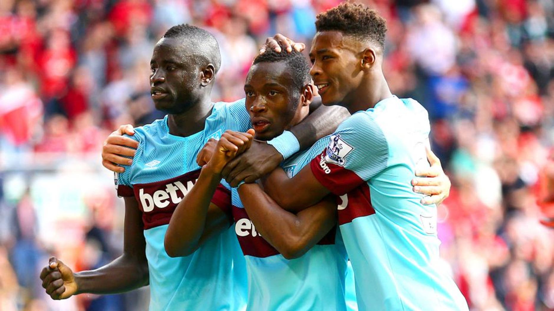LIVERPOOL, ENGLAND - AUGUST 29: Diafra Sakho (C) of West Ham United celebrates scoring his team's third goal with his team mates Cheikhou Kouyate (L) and Reece Oxford (R) during the Barclays Premier League match between Liverpool and West Ham United at Anfield on August 29, 2015 in Liverpool, England. (Photo by Clive Mason/Getty Images)