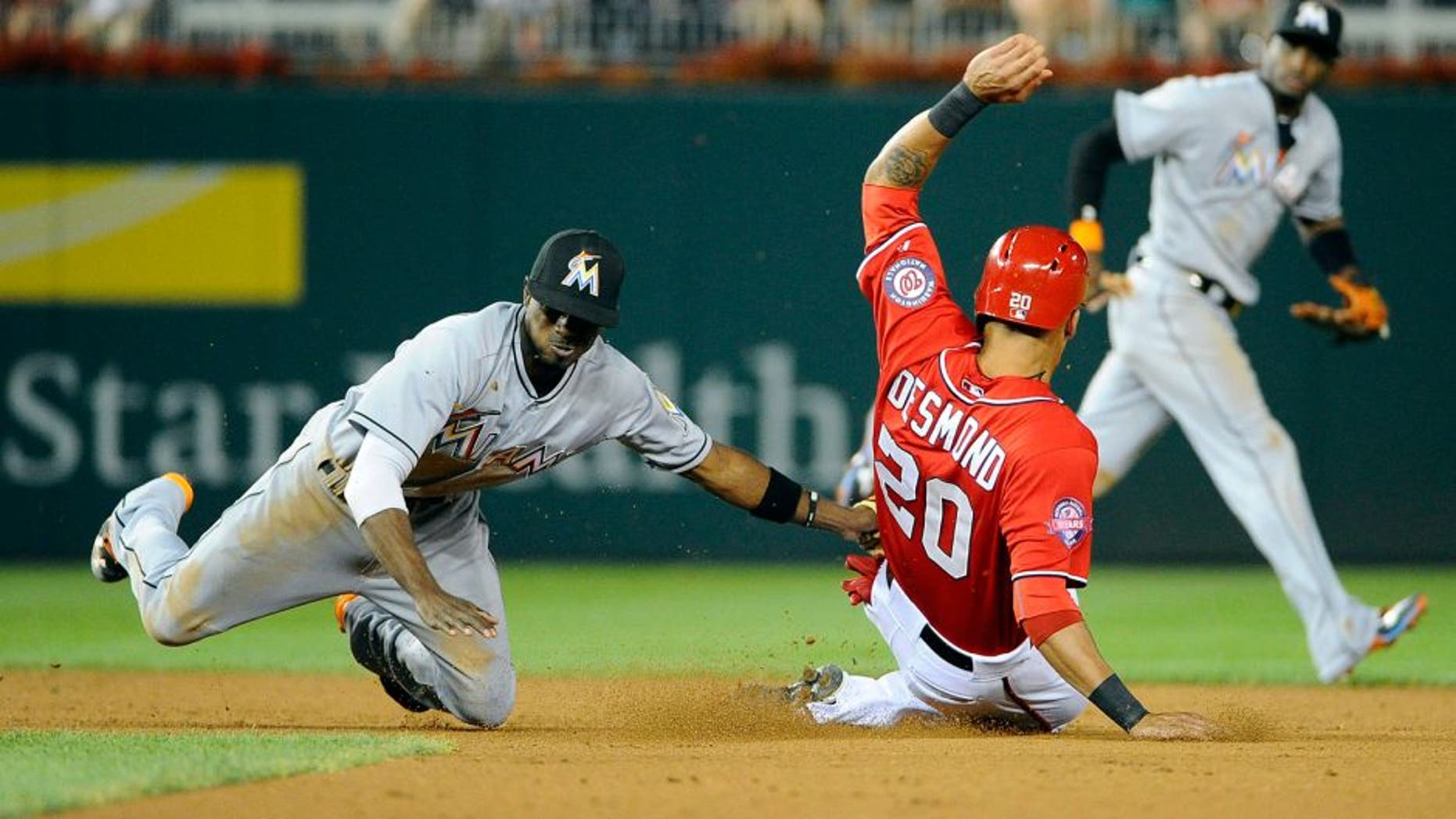 Aug 29, 2015; Washington, DC, USA; Miami Marlins second baseman Dee Gordon (9) tags out Washington Nationals shortstop Ian Desmond (20) attempting to steal second base during the fourth inning at Nationals Park. Mandatory Credit: Brad Mills-USA TODAY Sports