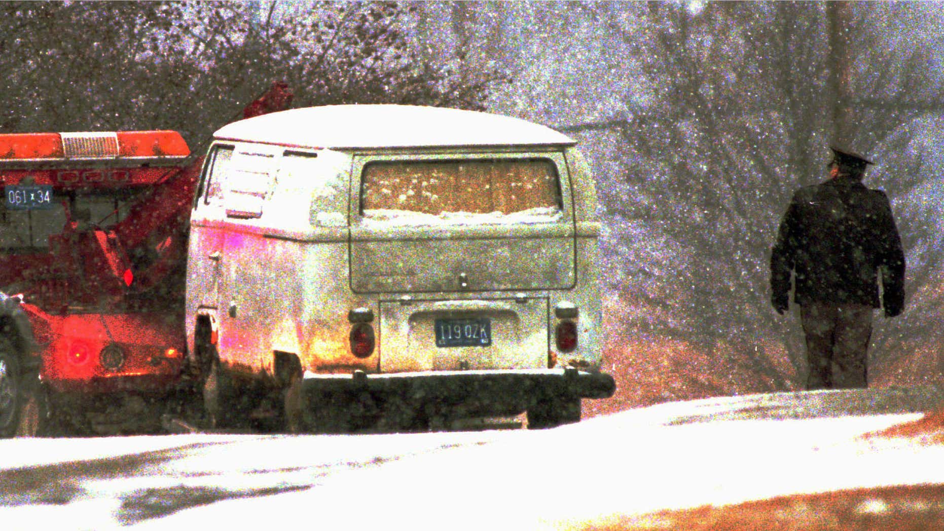 Jan. 29, 1996: A truck pulls Dr. Jack Kevorkian's minivan, which authorities said contained the body of a woman, away from a parking lot at the Medical Examiner's office in Pontiac, Mich.