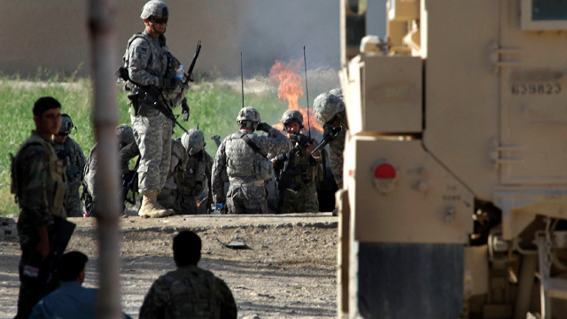 Aug. 30: U.S. and Afghan soldiers gather at the scene of a roadside bomb attack in Kandahar, Afghanistan.