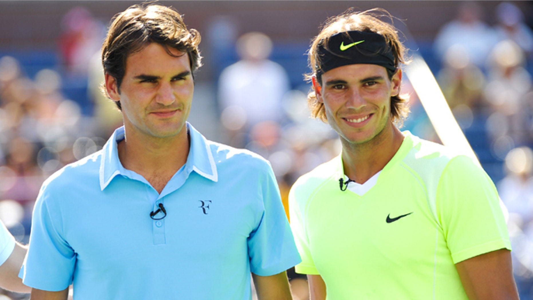 Tennis players Roger Federer, left, and Rafael Nadal look on during Arthur Ashe Kids Day at the USTA Billie Jean King National Tennis Center on Saturday, Aug. 28, 2010 in New York. (AP Photo/Evan Agostini)