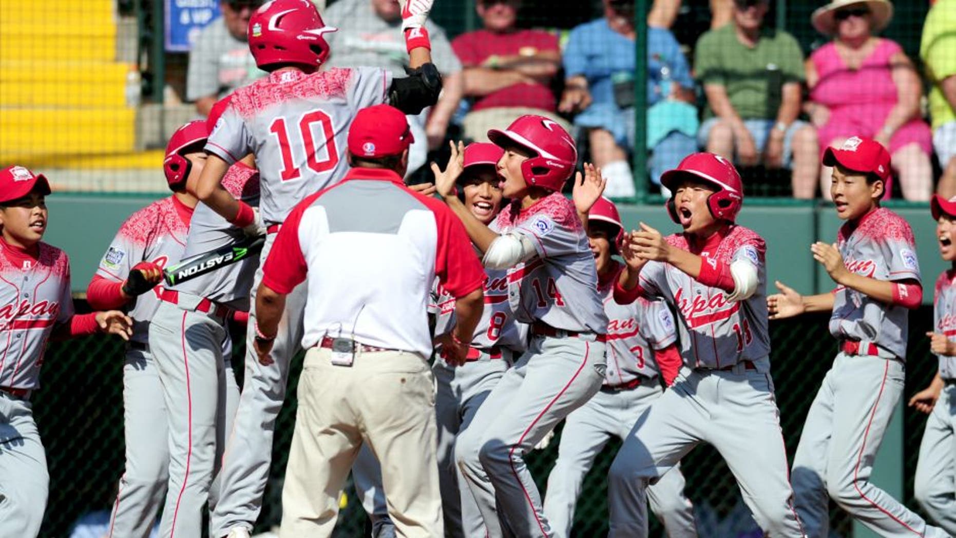 Aug 30, 2015; Williamsport, PA, USA; Japan Region outfielder Kengo Tomita (14) celebrates after hitting a home run in the second inning against the Mid-Atlantic Region at Howard J. Lamade Stadium. Mandatory Credit: Evan Habeeb-USA TODAY Sports