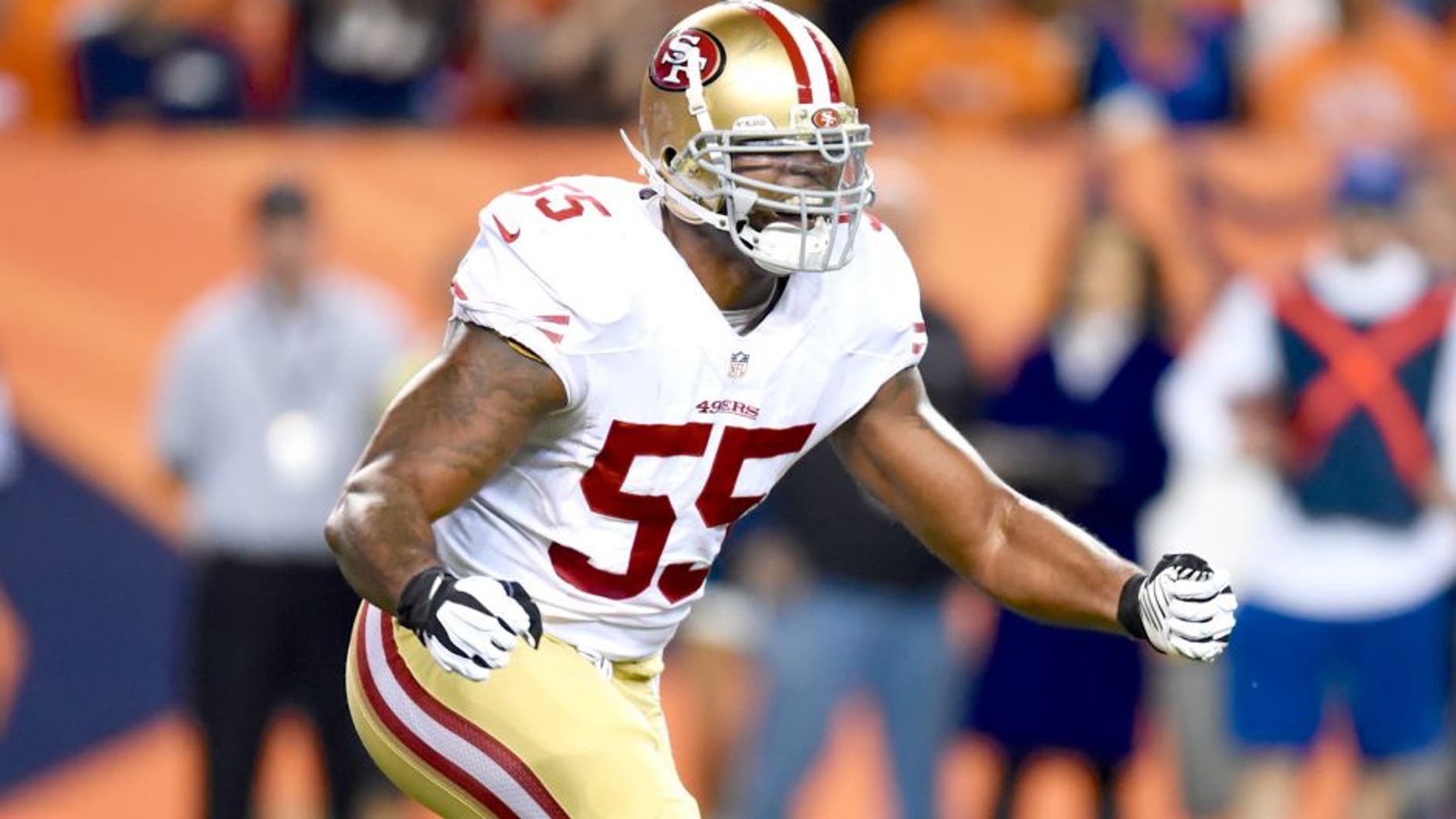 Oct 19, 2014; Denver, CO, USA; San Francisco 49ers outside linebacker Ahmad Brooks (55) reacts after a play in the first quarter against the Denver Broncos at Sports Authority Field at Mile High. Mandatory Credit: Ron Chenoy-USA TODAY Sports