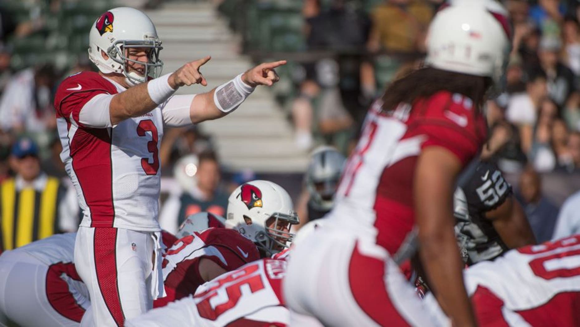 August 30, 2015; Oakland, CA, USA; Arizona Cardinals quarterback Carson Palmer (3) signals at the line of scrimmage against the Oakland Raiders during the first quarter in a preseason NFL football game at O.co Coliseum. Mandatory Credit: Kyle Terada-USA TODAY Sports