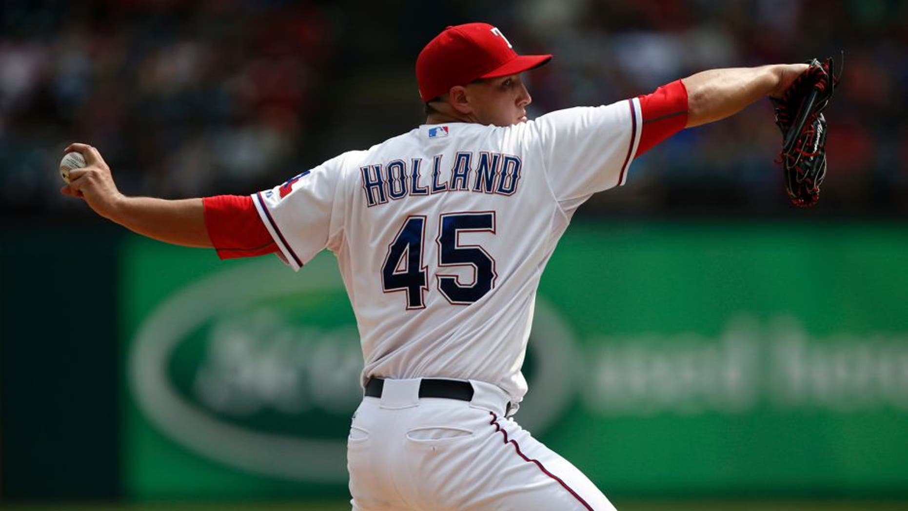 Aug 30, 2015; Arlington, TX, USA; Texas Rangers starting pitcher Derek Holland (45) delivers a pitch to the Baltimore Orioles during the fifth inning of a ballgame at Globe Life Park in Arlington. The Rangers won 6-0. Mandatory Credit: Jim Cowsert-USA TODAY Sports