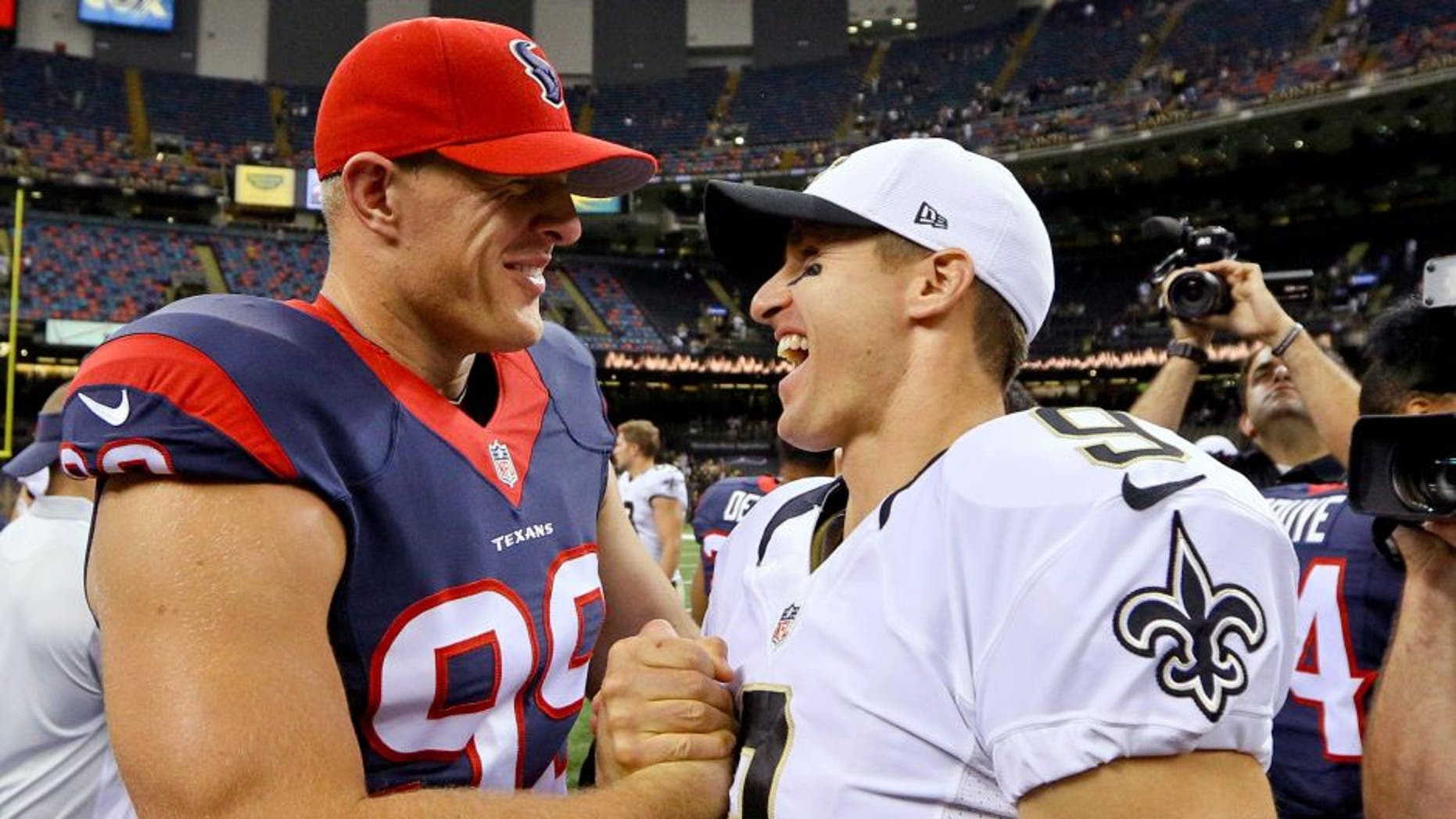 Aug 30, 2015; New Orleans, LA, USA; New Orleans Saints quarterback Drew Brees (9) and Houston Texans defensive end J.J. Watt (99) talk following a preseason game at the Mercedes-Benz Superdome. The Texans defeated the Saints 27-13. Mandatory Credit: Derick E. Hingle-USA TODAY Sports