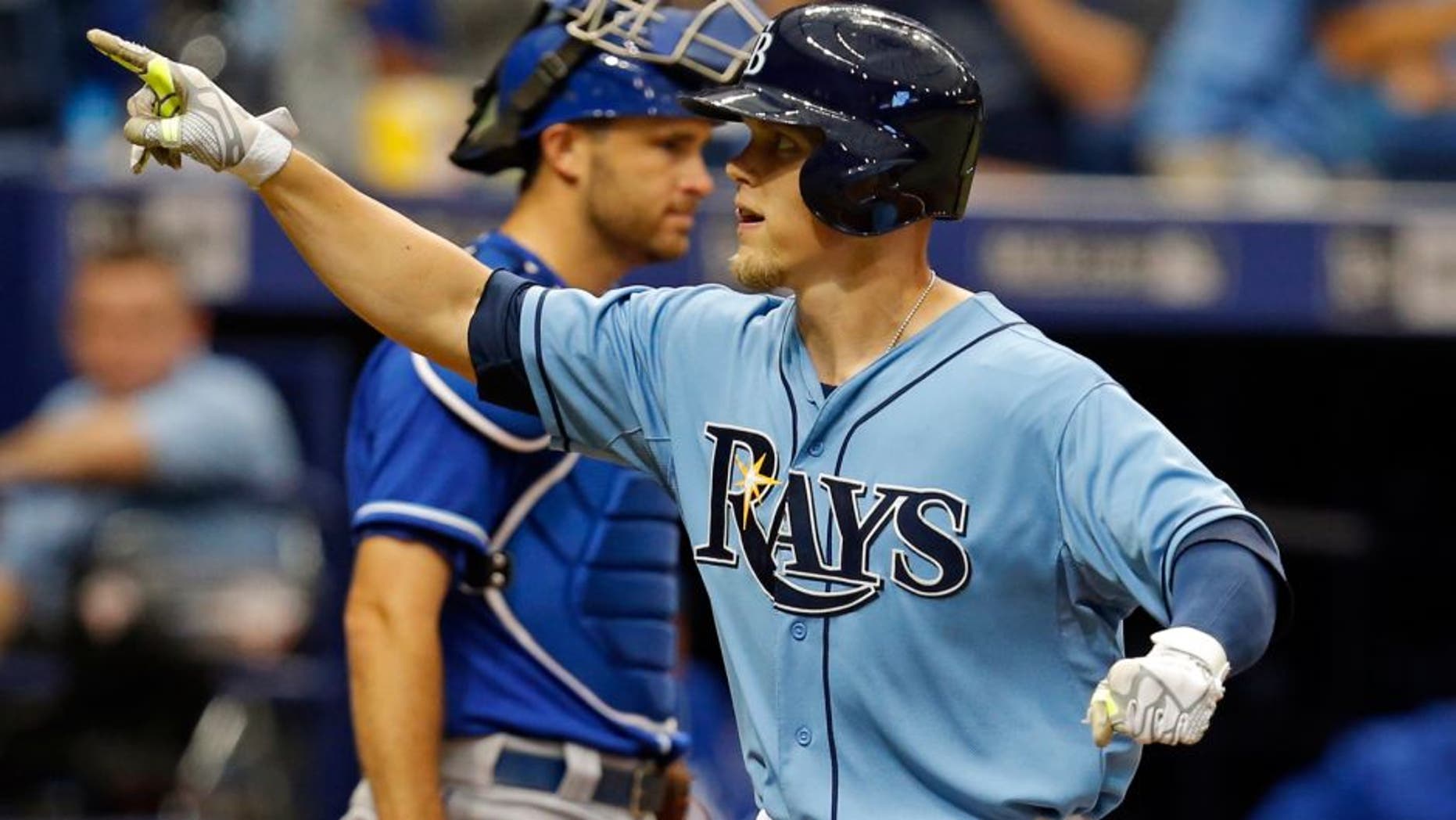 Tampa Bay Rays' Brandon Guyer celebrates as he crosses home plate in front of Kansas City Royals catcher Drew Butera after his home run during the third inning of a baseball game Sunday, Aug. 30, 2015, in St. Petersburg, Fla. (AP Photo/Mike Carlson)