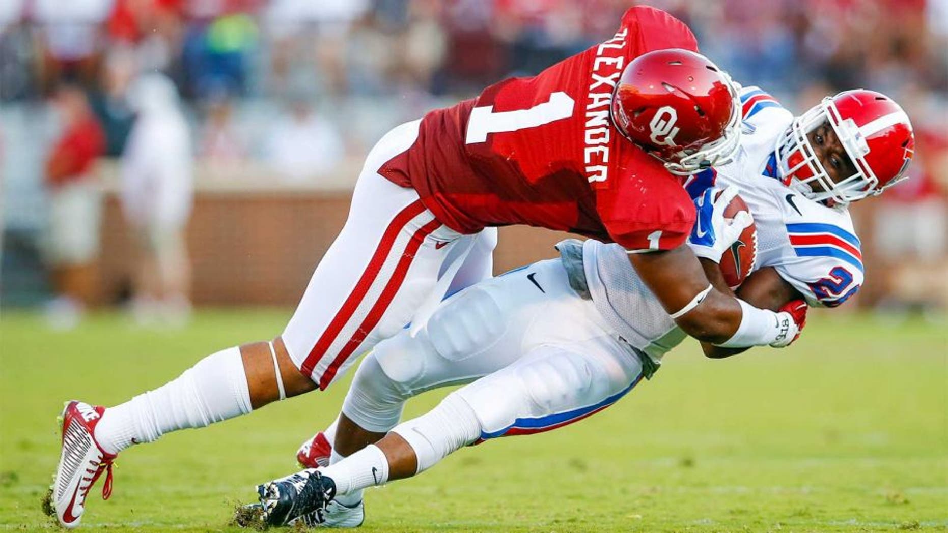 Aug 30, 2014; Norman, OK, USA; Oklahoma Sooners linebacker Dominique Alexander (1) tackles Louisiana Tech Bulldogs running back Kenneth Dixon (28) during the first half at Gaylord Family - Oklahoma Memorial Stadium. Mandatory Credit: Kevin Jairaj-USA TODAY Sports