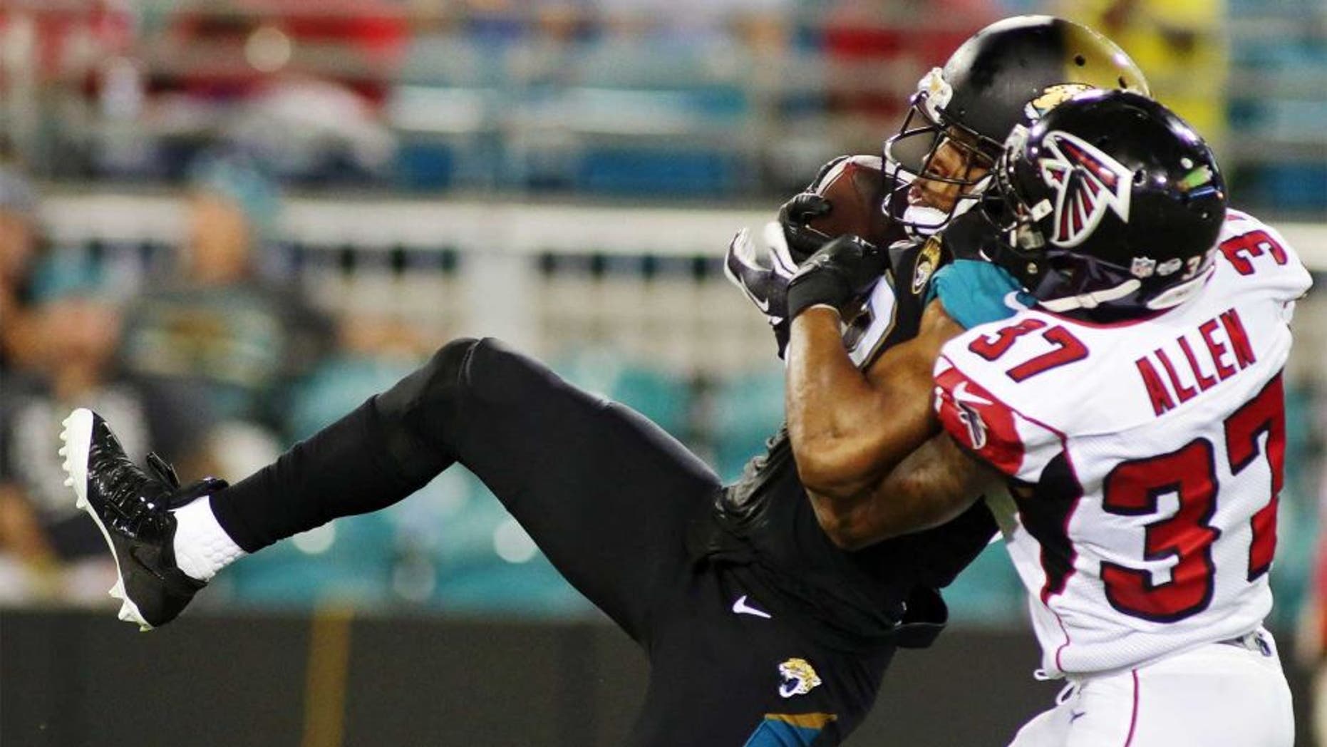 Aug 28, 2014; Jacksonville, FL, USA; Jacksonville Jaguars wide receiver Mike Brown (12) catches a pass as Atlanta Falcons cornerback Ricardo Allen (37) defends in the fourth quarter of their game at EverBank Field. The Atlanta Falcons won 24-14. Mandatory Credit: Phil Sears-USA TODAY Sports