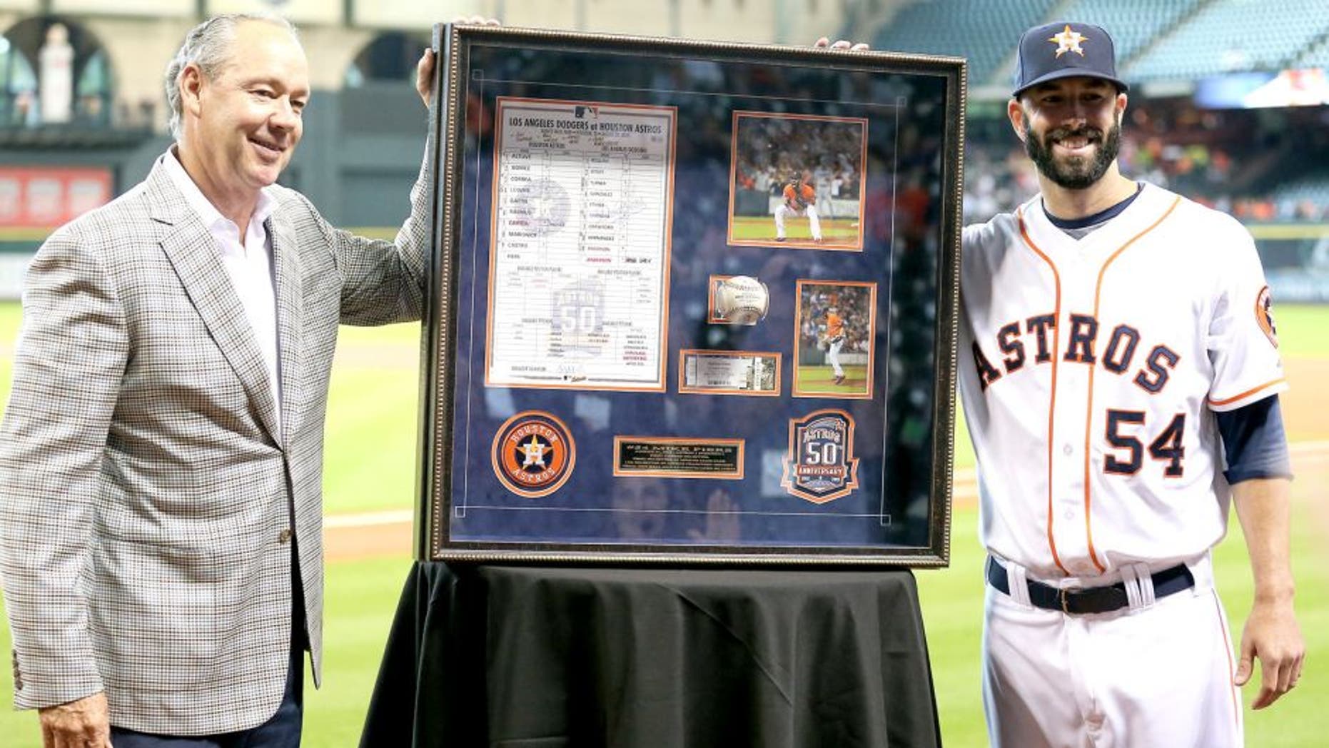 HOUSTON, TX - AUGUST 31: Mike Fiers #54 receives from Houston Astros owner Jim Crane a shadowbox of momentos from his no hitter on August 21, 2015 at Minute Maid Park on August 31, 2015 in Houston, Texas. (Photo by Bob Levey/Getty Images)