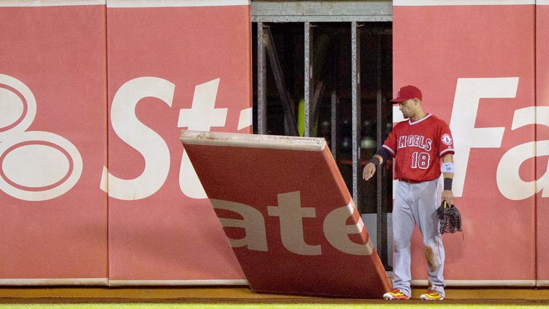 OAKLAND, CA - AUGUST 31: Shane Victorino #18 of the Los Angeles Angels of Anaheim watches as a piece of the outfield wall falls onto the field during the fifth inning against the Oakland Athletics at O.co Coliseum on August 31, 2015 in Oakland, California. (Photo by Jason O. Watson/Getty Images)