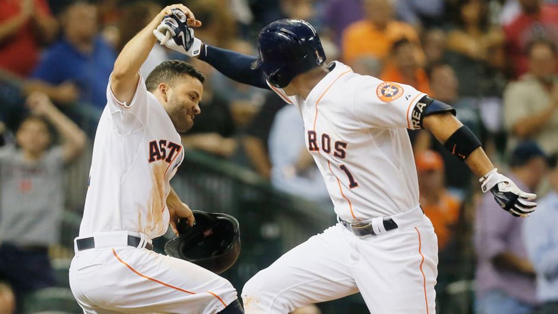 HOUSTON, TX - AUGUST 31: Carlos Correa #1 of the Houston Astros is congratulated by Jose Altuve #27 after hitting a home run in the fifth inning against the Seattle Mariners at Minute Maid Park on August 31, 2015 in Houston, Texas. (Photo by Bob Levey/Getty Images)