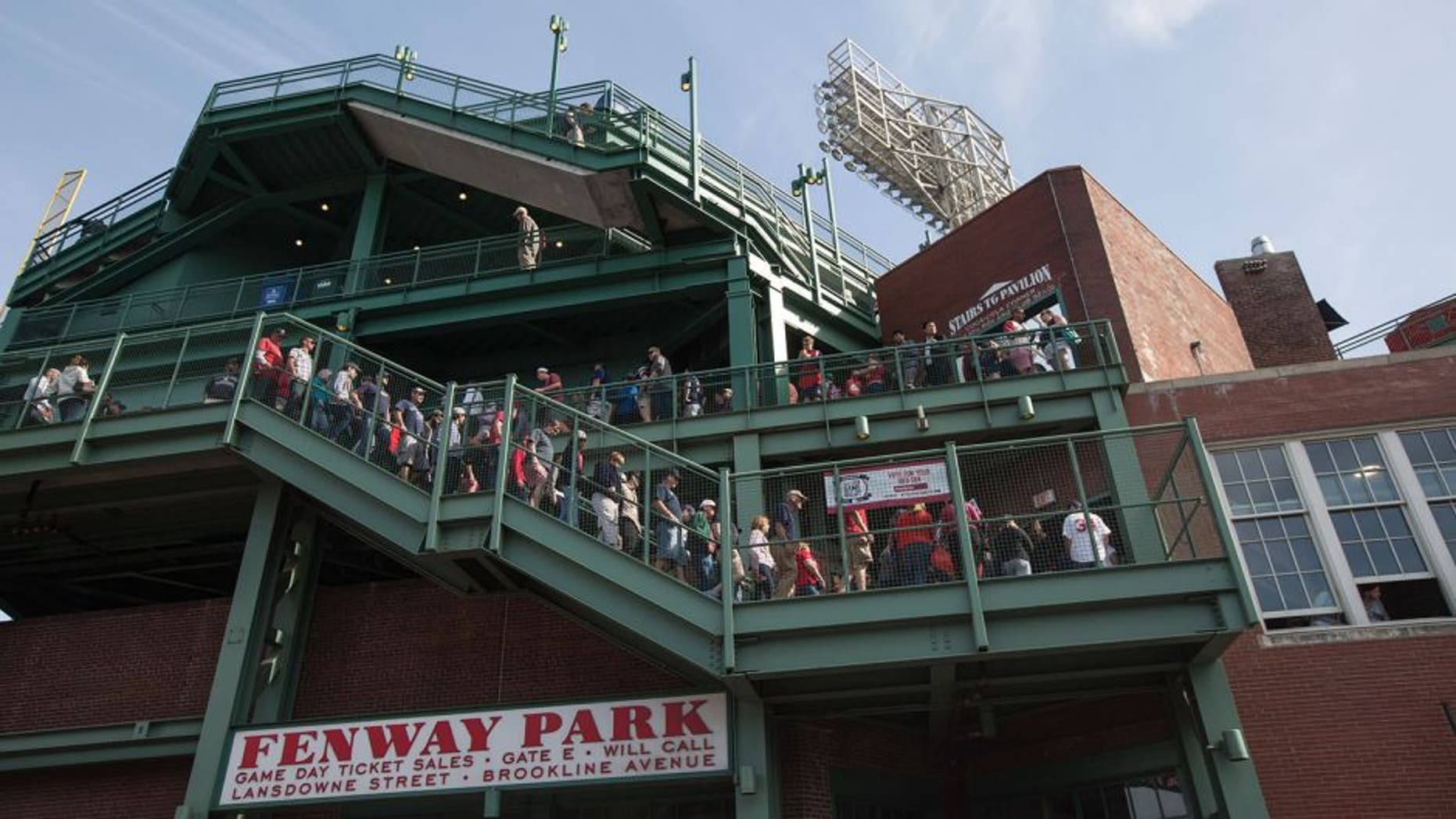 BOSTON - JUNE 7: Fans walk through Fenway Park in Boston, Mass., June 7, 2015. A little known, more than a century old so-called baseball rule, states that stadium owners and operators are not responsible for injuries sustained by foul balls or shards of bat so long as netted or screened seats are available to the vast majority of spectators. (Photo by Keith Bedford for The Boston Globe via Getty Images)