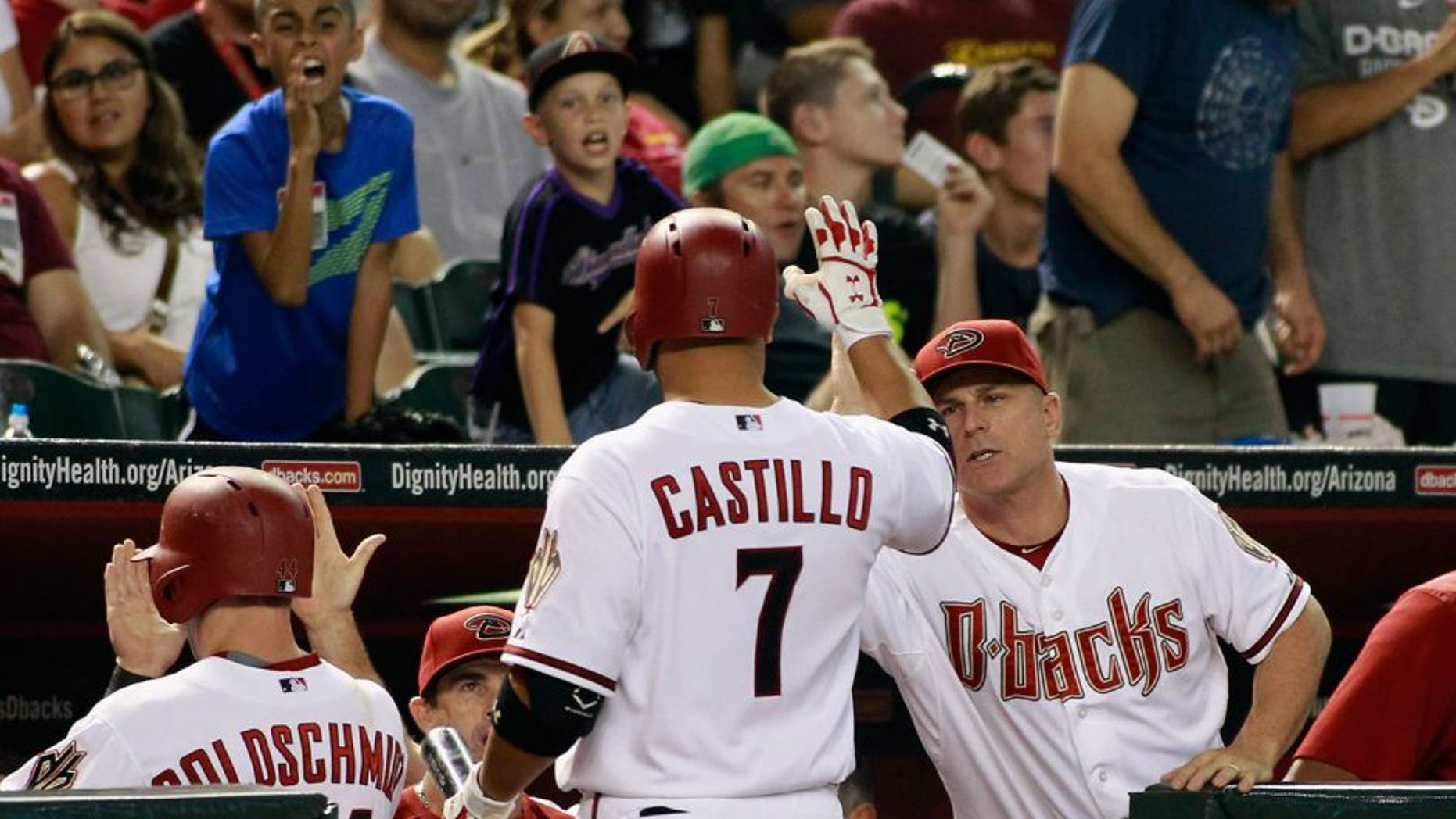 PHOENIX, AZ - AUGUST 28: Welington Castillo #7 of the Arizona Diamondbacks is congratulated by manager Chip Hale #3 (R) after hitting a sacrifice fly against the Oakland Athletics to score Paul Goldschmidt #44 (L) during the sixth inning of a MLB game at Chase Field on August 28, 2015 in Phoenix, Arizona. The Diamondbacks defeated the Athletics 6-4. (Photo by Ralph Freso/Getty Images)