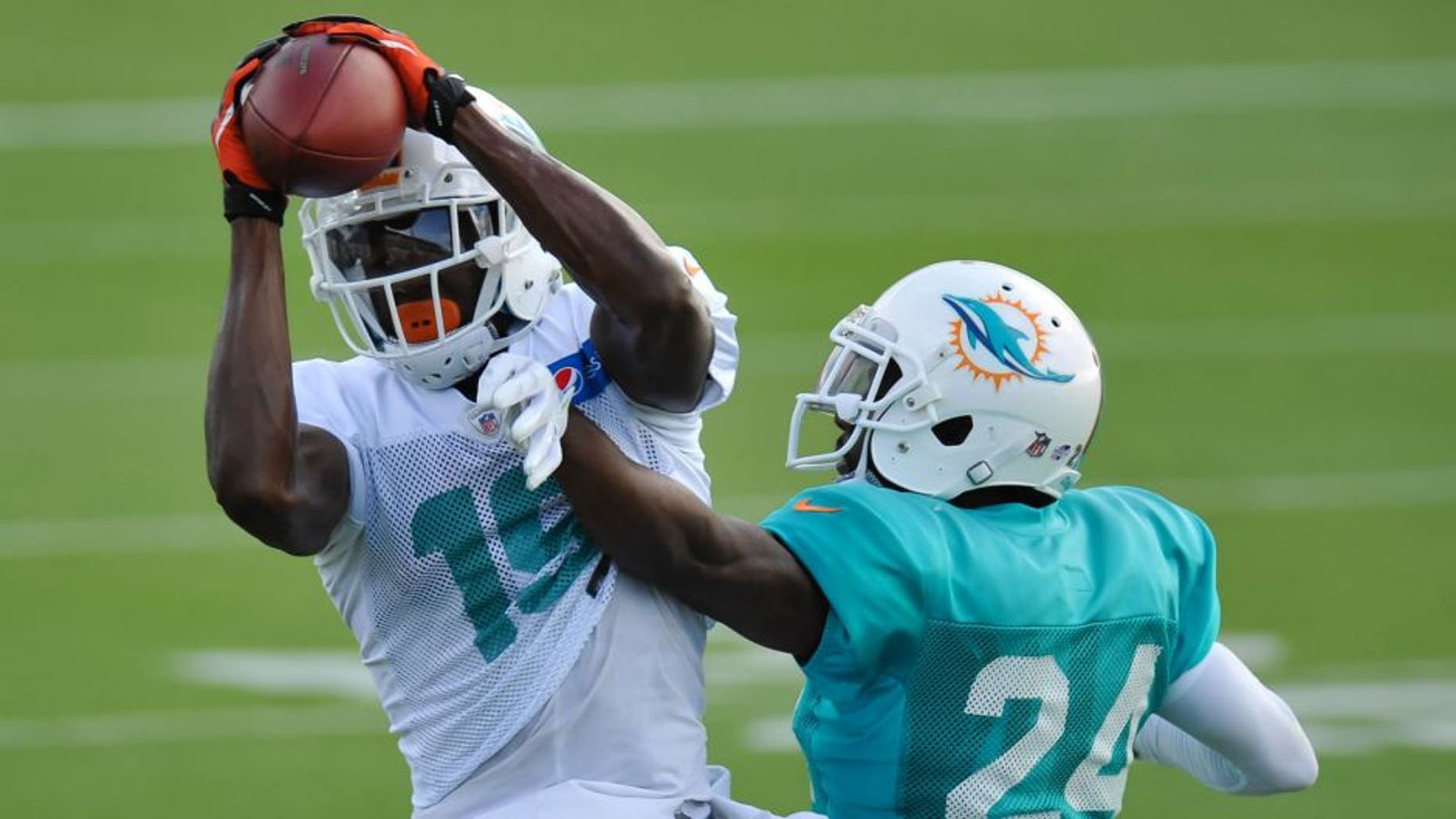 Aug 11, 2015; Davie, FL, USA; Miami Dolphins wide receiver Michael Preston (19) hauls in a catch in front of Miami Dolphins corner back Brice McCain (24) during training camp at Doctors Hospital Training Facility. Mandatory Credit: Steve Mitchell-USA TODAY Sports