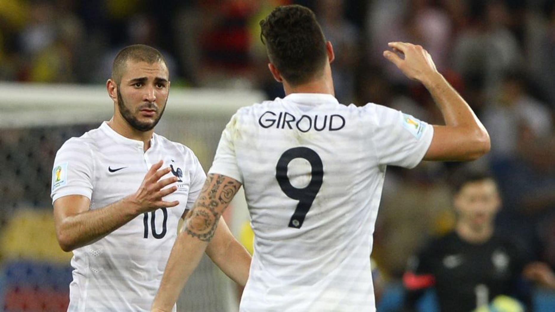 France's forward Olivier Giroud (R) and France's forward Karim Benzema shake hands after drawing 0-0 at the end of the Group E football match between Ecuador and France at the Maracana Stadium in Rio de Janeiro during the 2014 FIFA World Cup on June 25, 2014. AFP PHOTO / FRANCK FIFE (Photo credit should read FRANCK FIFE/AFP/Getty Images)