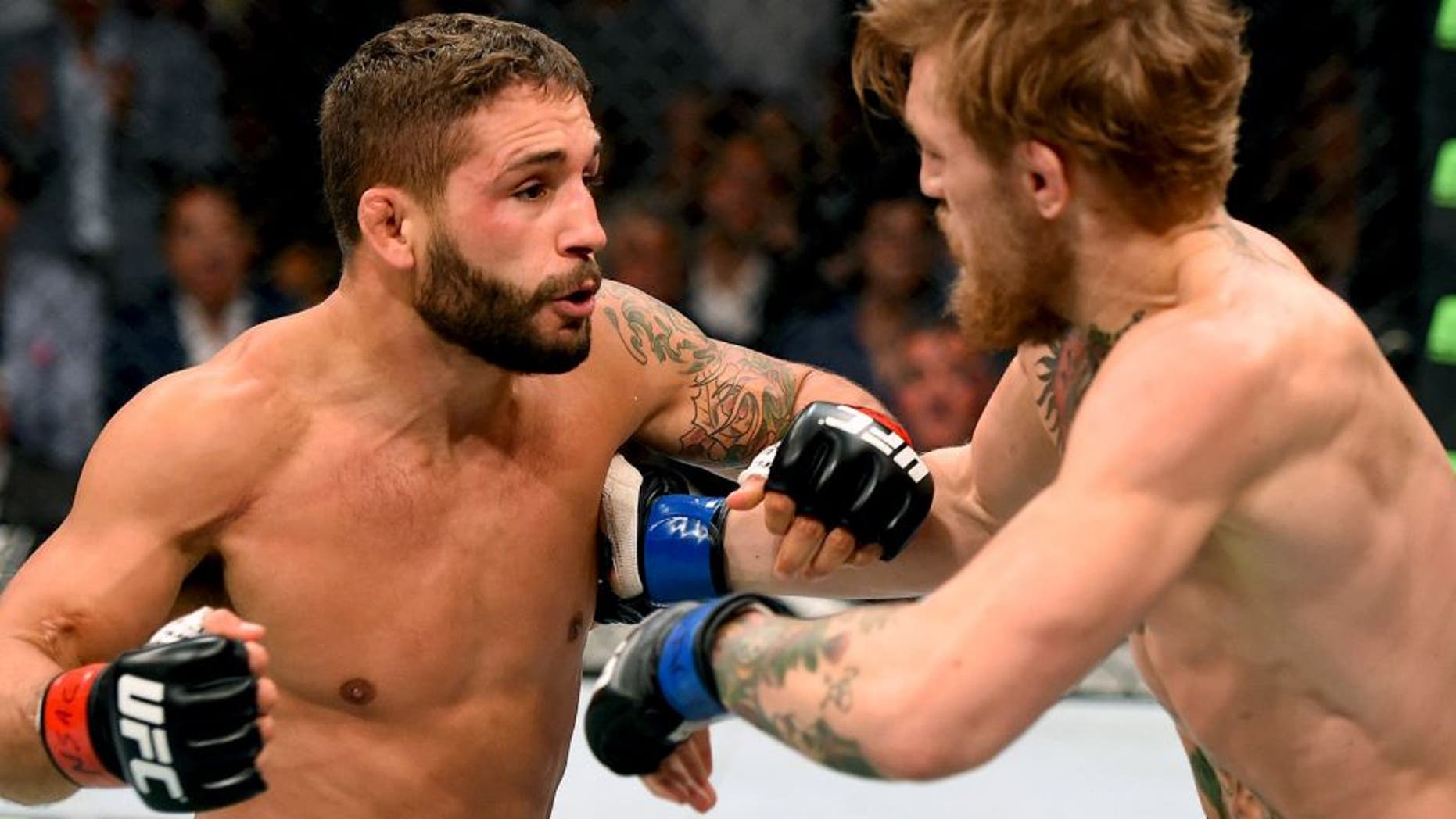 LAS VEGAS, NV - JULY 11: (L-R) Chad Mendes punches Conor McGregor in their UFC interim featherweight title fight during the UFC 189 event inside MGM Grand Garden Arena on July 11, 2015 in Las Vegas, Nevada. (Photo by Josh Hedges/Zuffa LLC/Zuffa LLC via Getty Images)