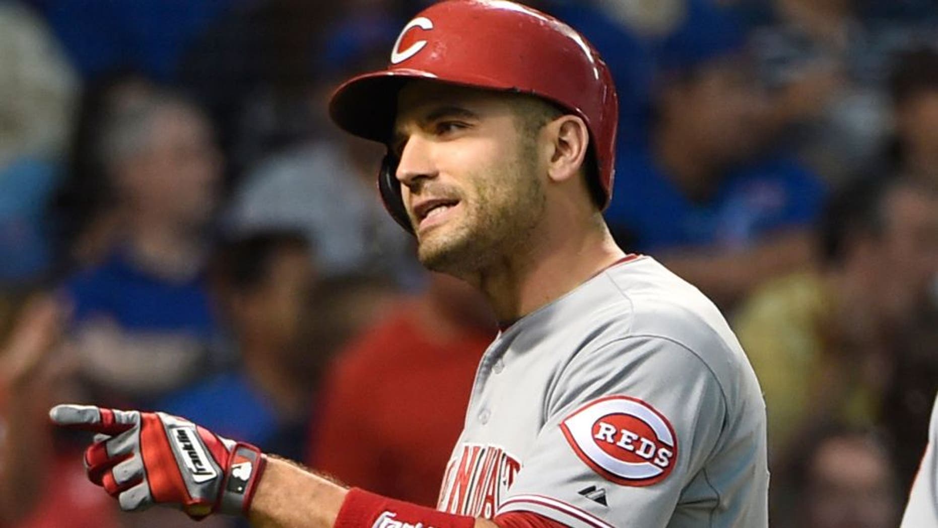 Jun 13, 2015; Chicago, IL, USA; Cincinnati Reds first baseman Joey Votto (19) reacts as he crosses home plate after hitting a home run against the Chicago Cubs during the fourth inning at Wrigley Field. Mandatory Credit: David Banks-USA TODAY Sports
