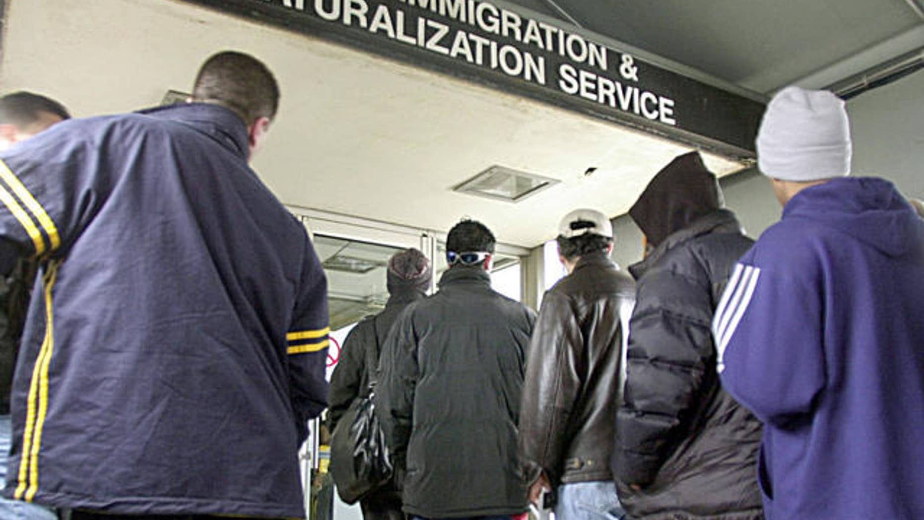 Immigrants line up outside an immigration office in Michigan. The state's governor, Rick Snyder, Republican, says foreign nationals have been an asset to the state and that Michigan's ailing economy needs to attract more immigrants.