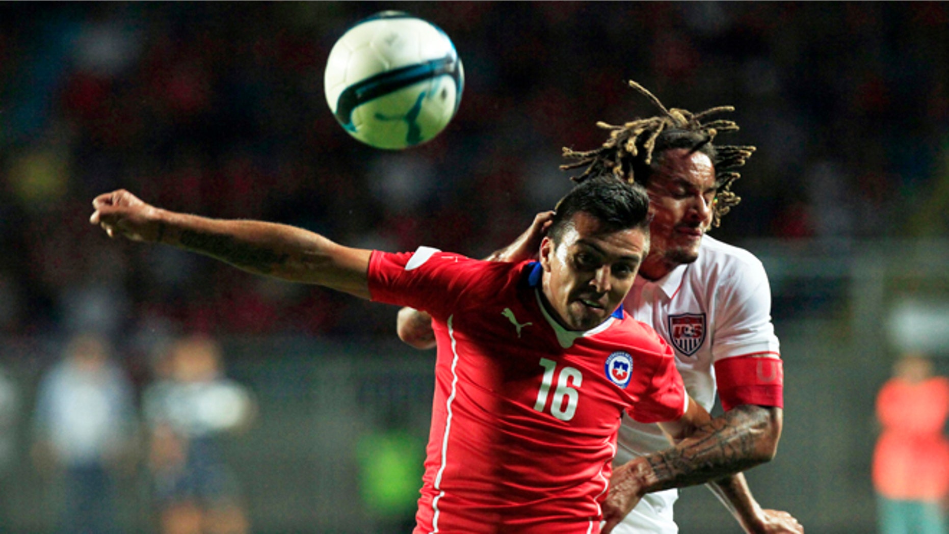 U.S. player Jermain Jones, behind, fights for the ball with Chile's Gonzalo Fierro during a friendly soccer match in Rancagua, Chile, Wednesday, Jan. 28, 2015. (AP Photo/Luis Hidalgo)