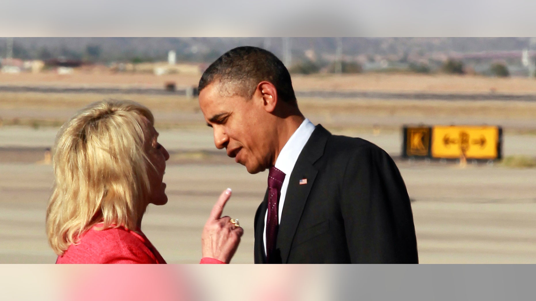 Arizona Gov. Jan Brewer points at President Barack Obama after he arrived at Phoenix-Mesa Gateway Airport. (AP Photo/Haraz N. Ghanbari)