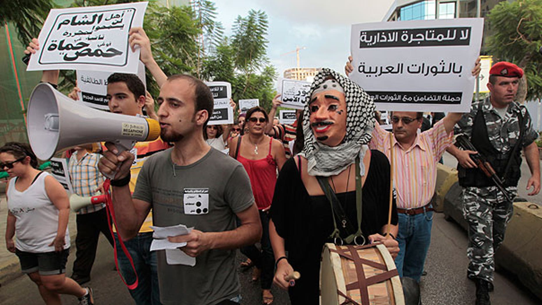 Aug. 15: Lebanese anti-Syrian regime protesters shout slogans against Syrian President Bashar Assad as they hold up Arabic placards as they protest during a demonstration in Beirut, Lebanon.