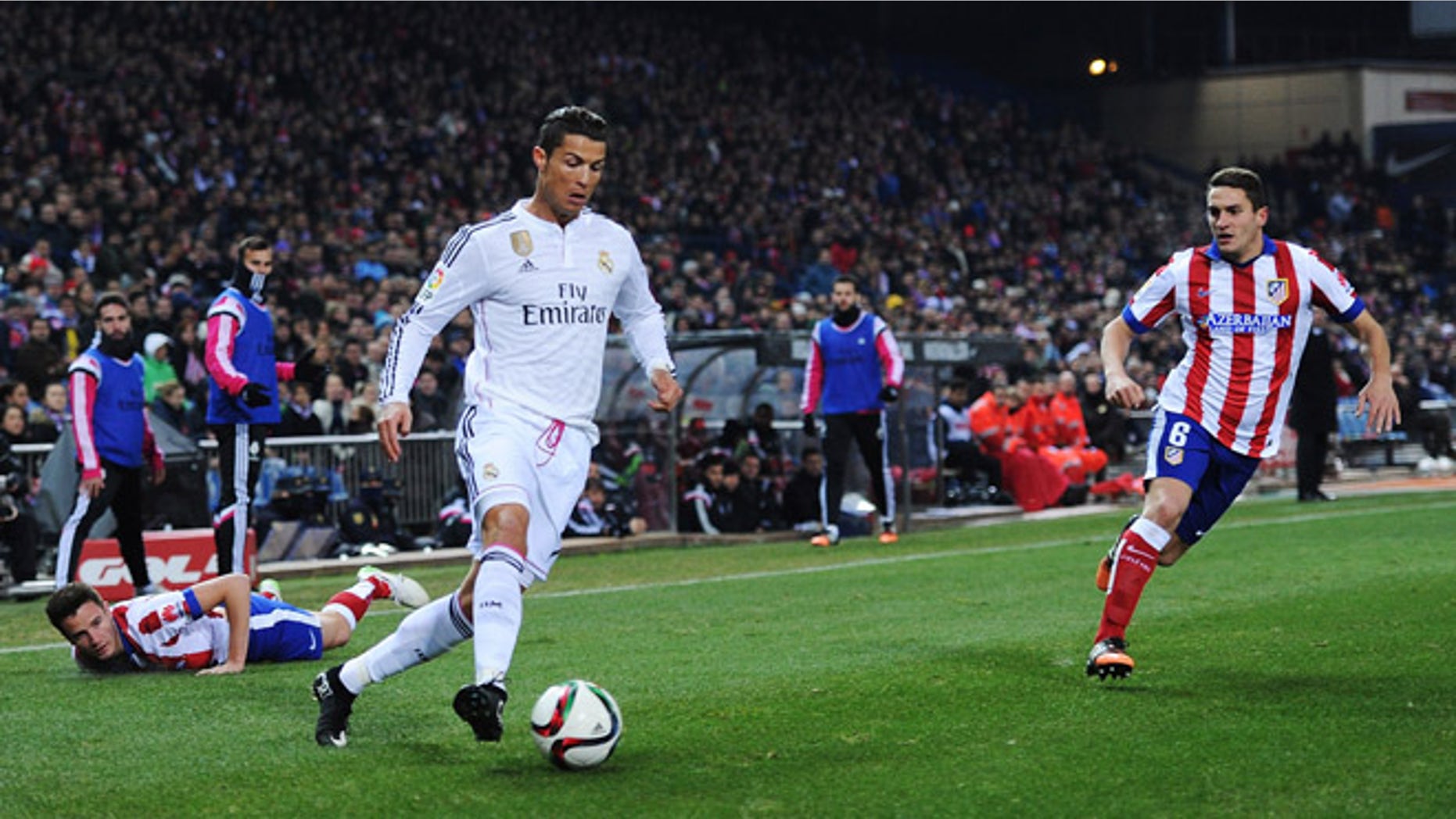 Cristiano Ronaldo gets past Ruben Mesa during match between Club Atletico and Real Madrid on January 7, 2015 in Madrid, Spain.