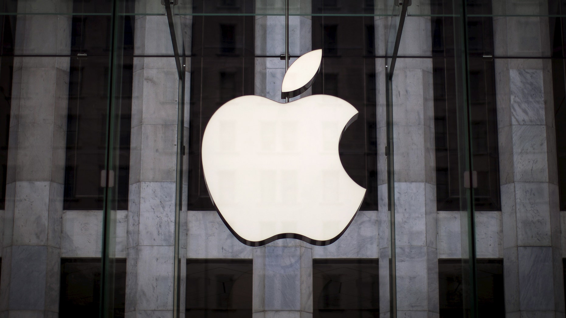 File photo - An Apple logo hangs above the entrance to the Apple store on 5th Avenue in the Manhattan borough of New York City, July 21, 2015. (REUTERS/Mike Segar)