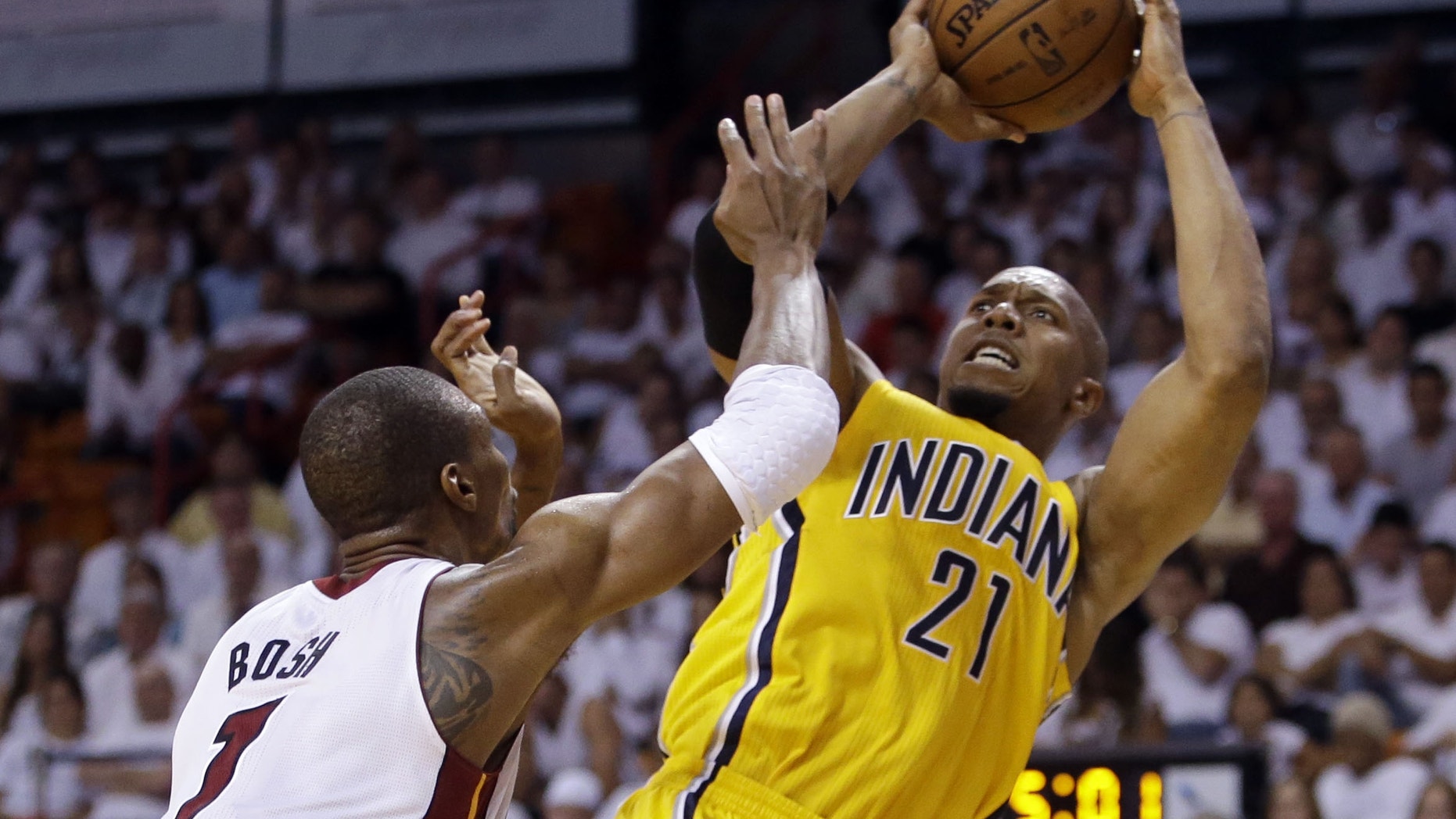 Indiana Pacers forward David West (21) attempts a basket over Miami Heat defender Chris Bosh (1) during the first half of Game 2 in their NBA basketball Eastern Conference finals playoff series, Friday, May 24, 2013, in Miami. (AP Photo/Lynne Sladky)